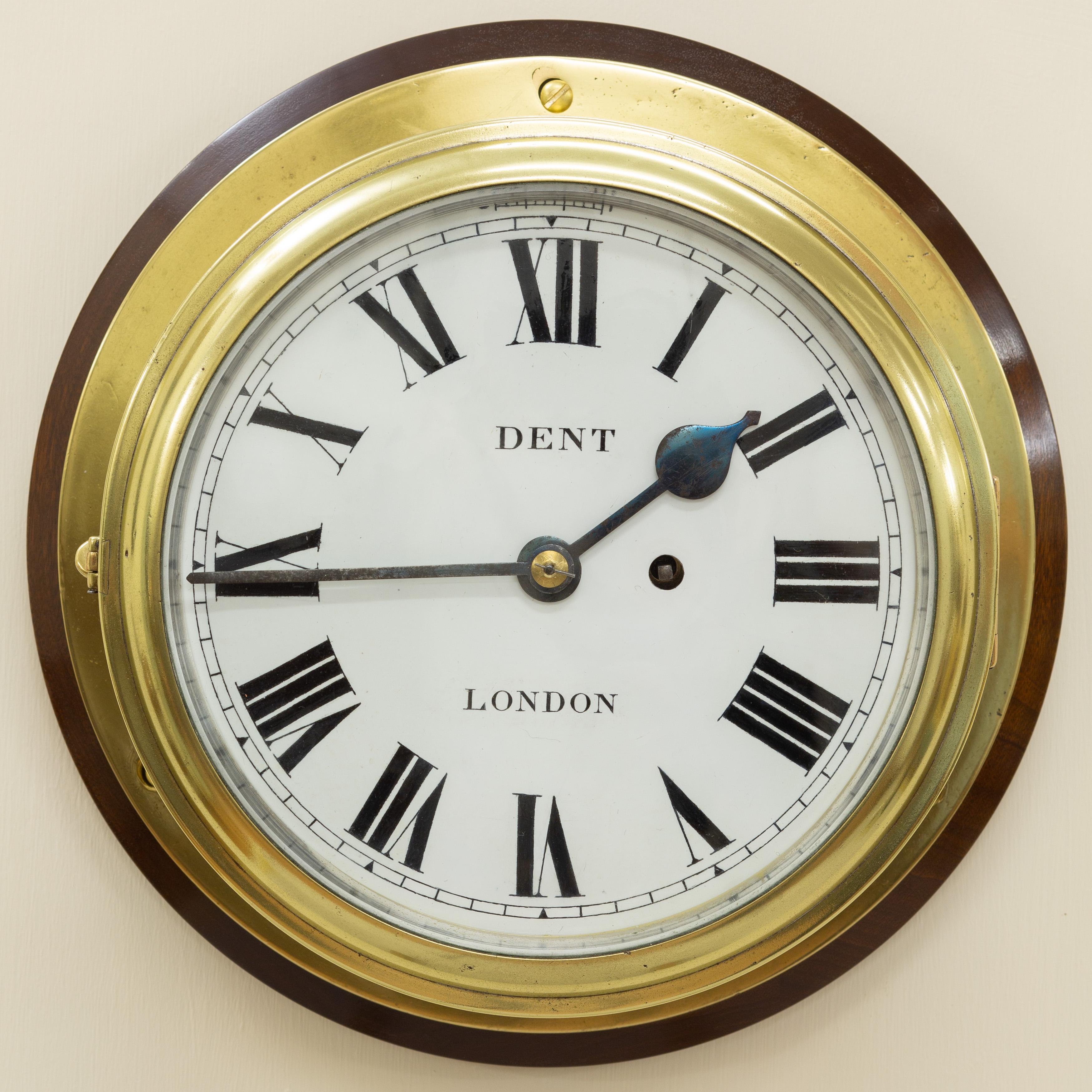 Large brass ships bulkhead clock.


Eight inch enamel dial with Roman numerals, ‘blued’ steel hands and signed ‘Dent, London’.

Heavy cast brass bezel with side ‘keep’ and bevelled glass.

Substantial eight day chain Fusee movement with large