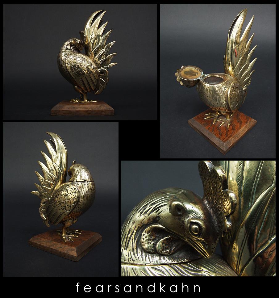 Victorian cockerel inkwell designed and manufactured in the UK.

Decorative brass form with a hinged head and removable ink tray.

Square oak plinth.

Measure: H 25cm x L 12cm x W 12cm.