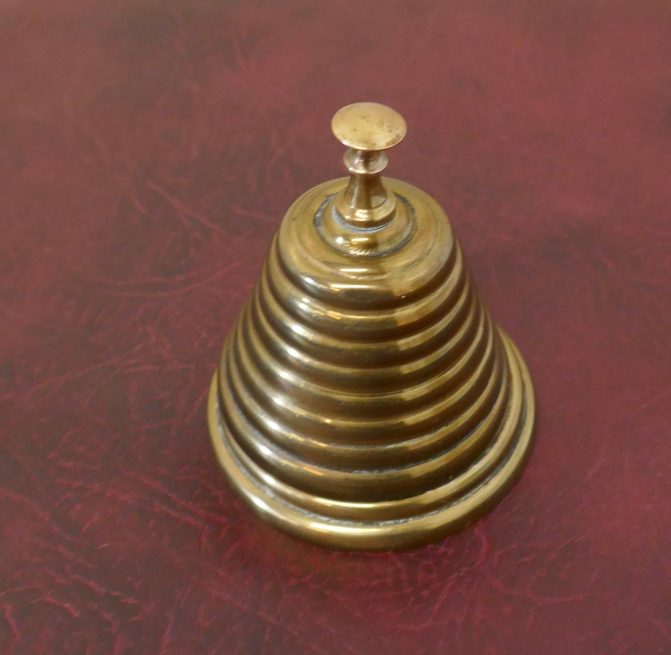 Victorian brass courtesy counter top bell, beehive brass bell

Made in the style of a beehive solid brass, good and ready to use with a high pitched ding, the bell is 3” in diameter and 4” high 
AC37.