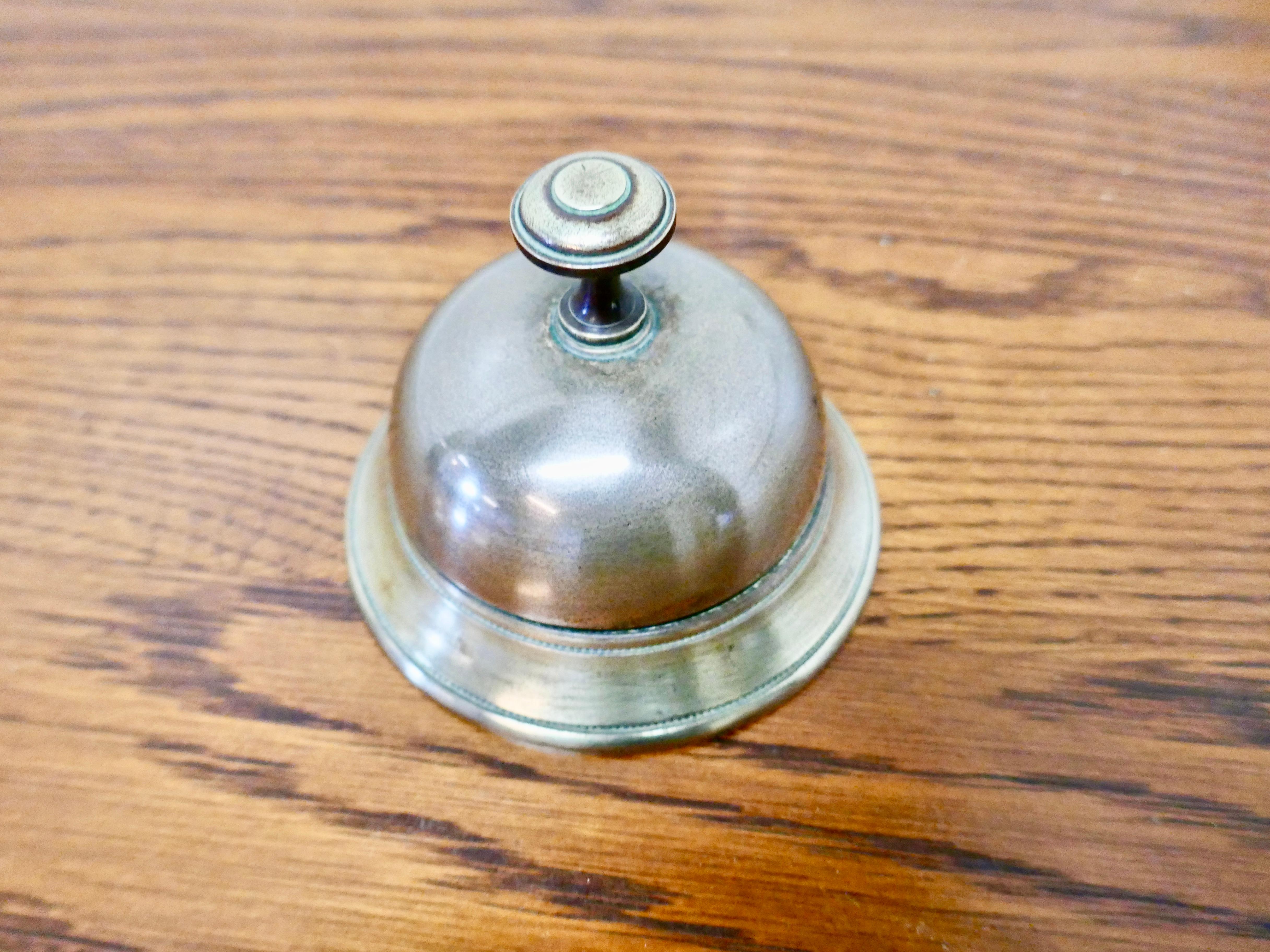 Victorian brass courtesy counter top bell, reception desk bell

Made in solid brass, in good read to use with a demanding ding, the bell is 4” in diameter and 4” high 
GB133.