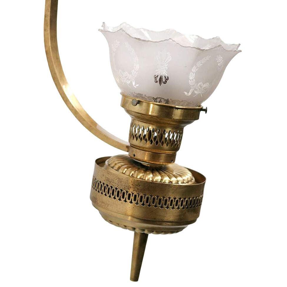 Late Victorian solid brass wall sconce with oil lamp converted to electric sockets. This solid brass wall sconce exudes timeless elegance with its classic silhouette and rich patina. The frosted acid-etched shade touch comes with a fluted design,