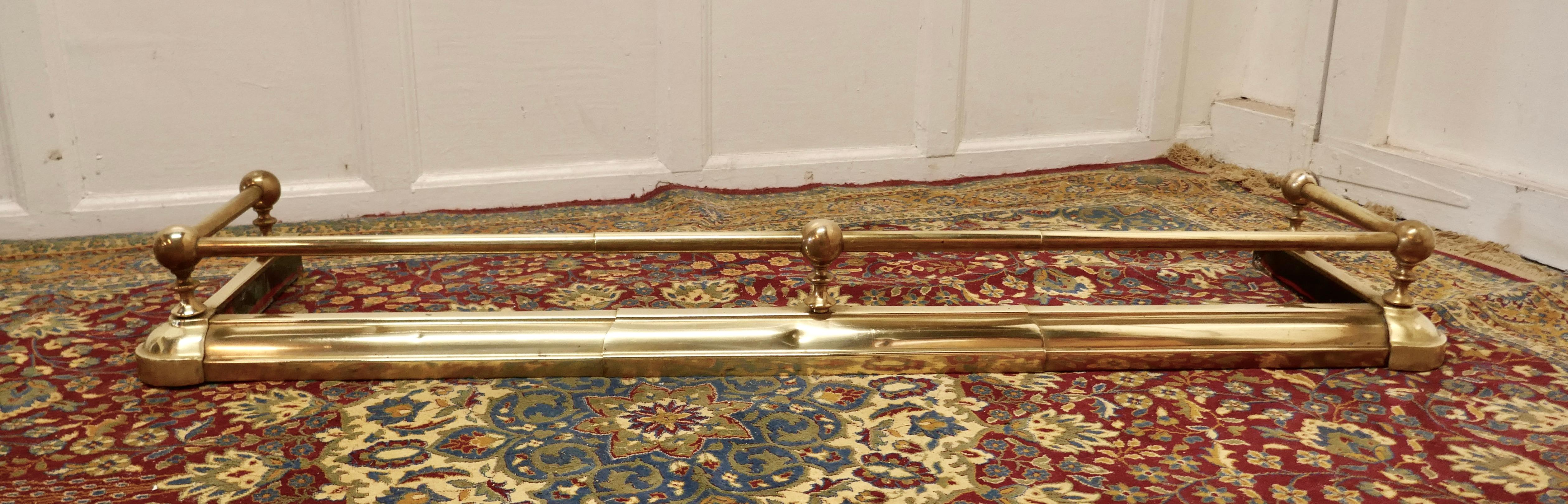 Victorian brass fender 

This is a very attractive Brass Fender it has a simple brass base with a brass rail above and chunky Brass Knobs supporting the rail 
The Fender is in good condition it is 6” high, 51” long and 15” deep
TAC28.