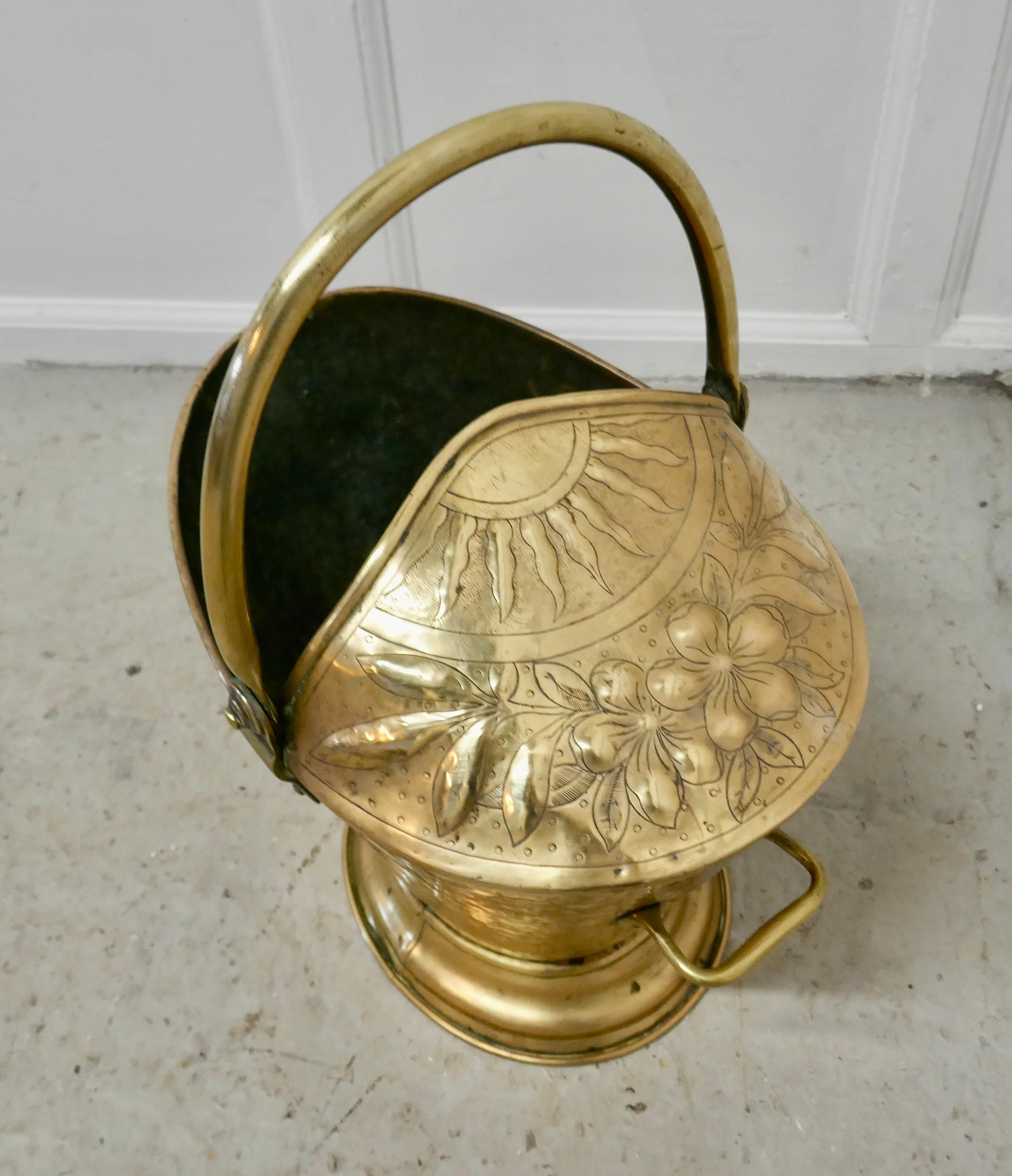 Victorian brass helmet coal scuttle 

This bucket is a very attractive partly enclosed oval shape, it is made in Brass with a hooped handle, it is decorated with a flaming sun and flowers
The scuttle is in good used condition, it has no faults just