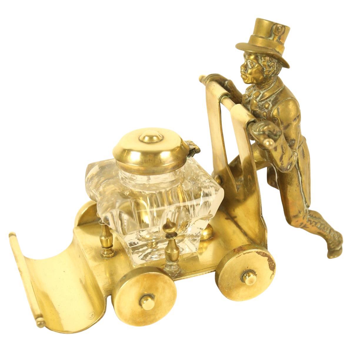 Victorian Brass ink stand  in the form of a  Gentleman Pushing a cart