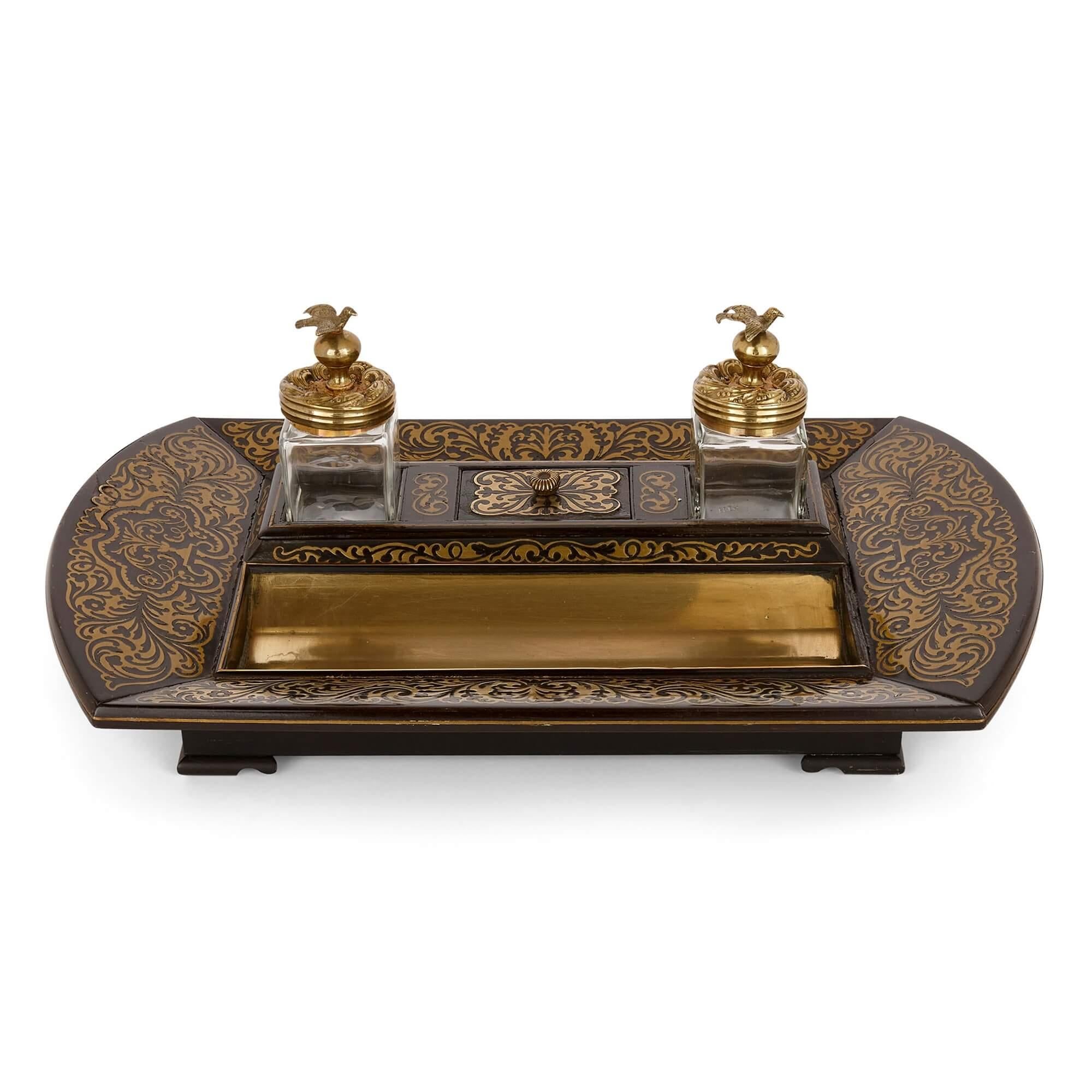Victorian brass inlaid ebonised wood Boulle inkstand
English, 19th century
Measures: height 12.5cm, width 38cm, depth 23.5cm

Made from ebonised wood and inlaid with brass in the manner of the Boulle marquetry technique, this beautiful piece is