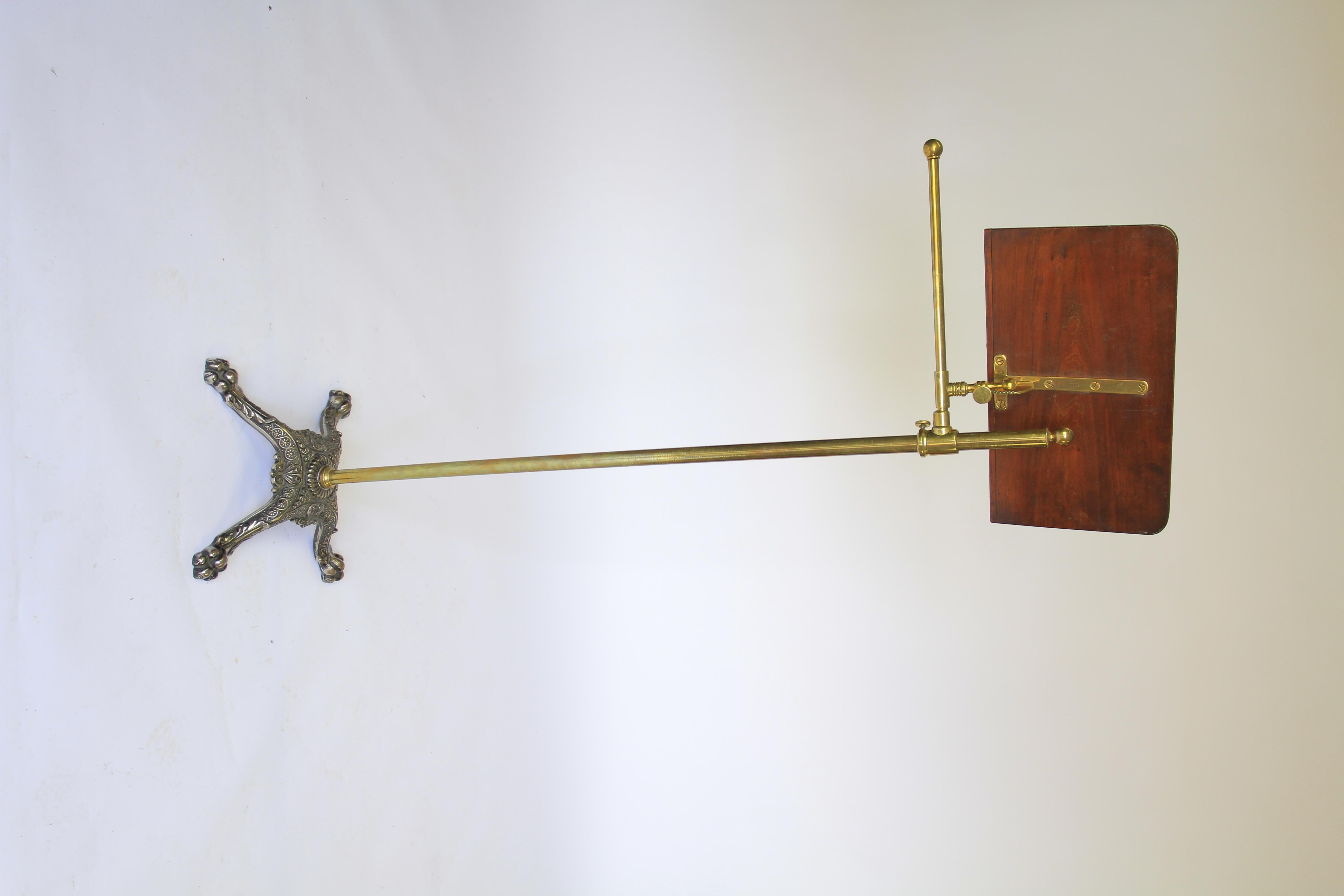 Victorian Brass & iron reading stand with Mahogany lectern
Brass pole with screw top  ball finial
Brass D shape arm holding Mahogany lectern,
sliding action , &  pinch screw  adjusting tilting action on lectern
Pair Brass book rests on front of