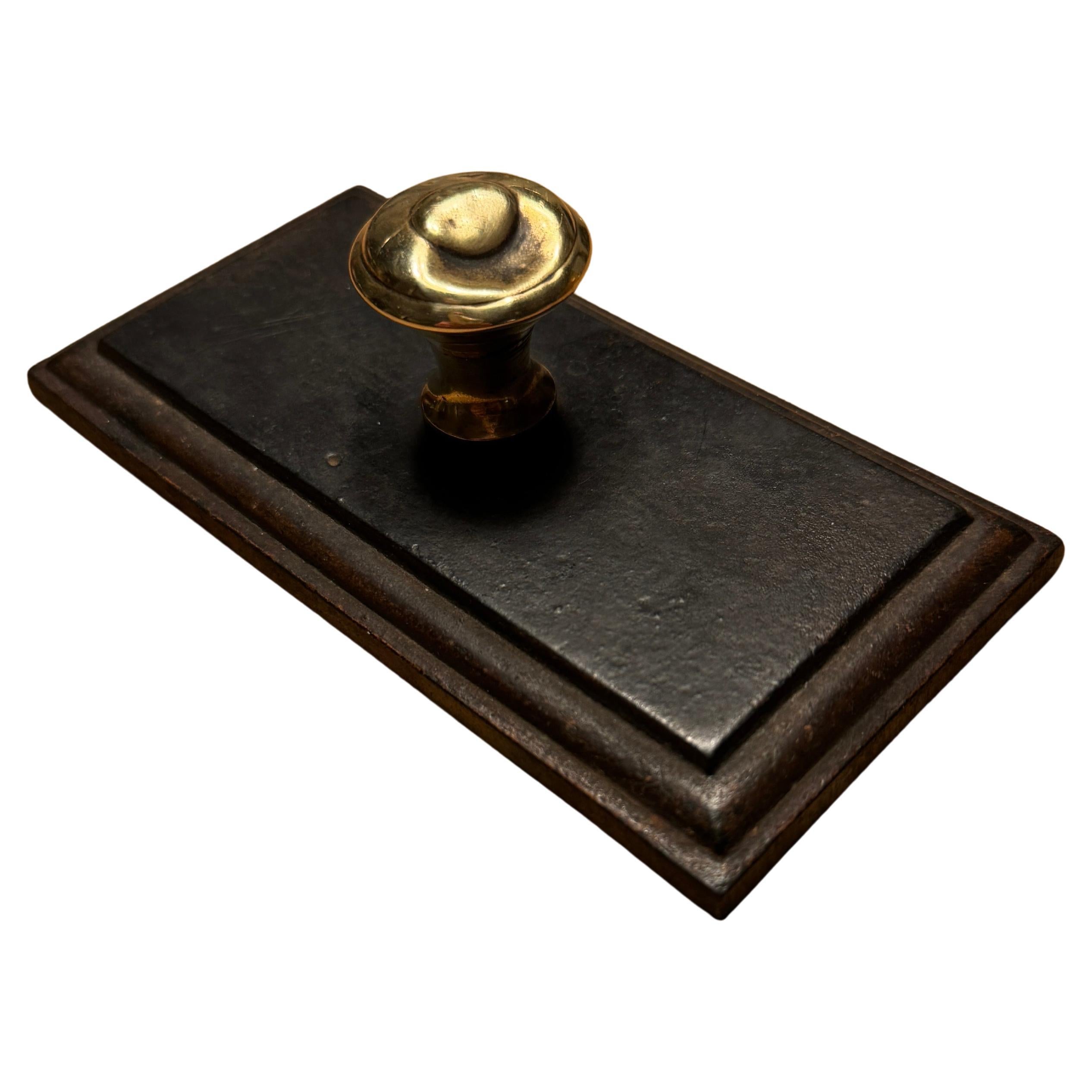 Rectangular Solid Bevelled Iron and Brass Knob Paper Weight, Mid 19th Century.
This truly charming Victorian desk accessory is very decorative and functional. 