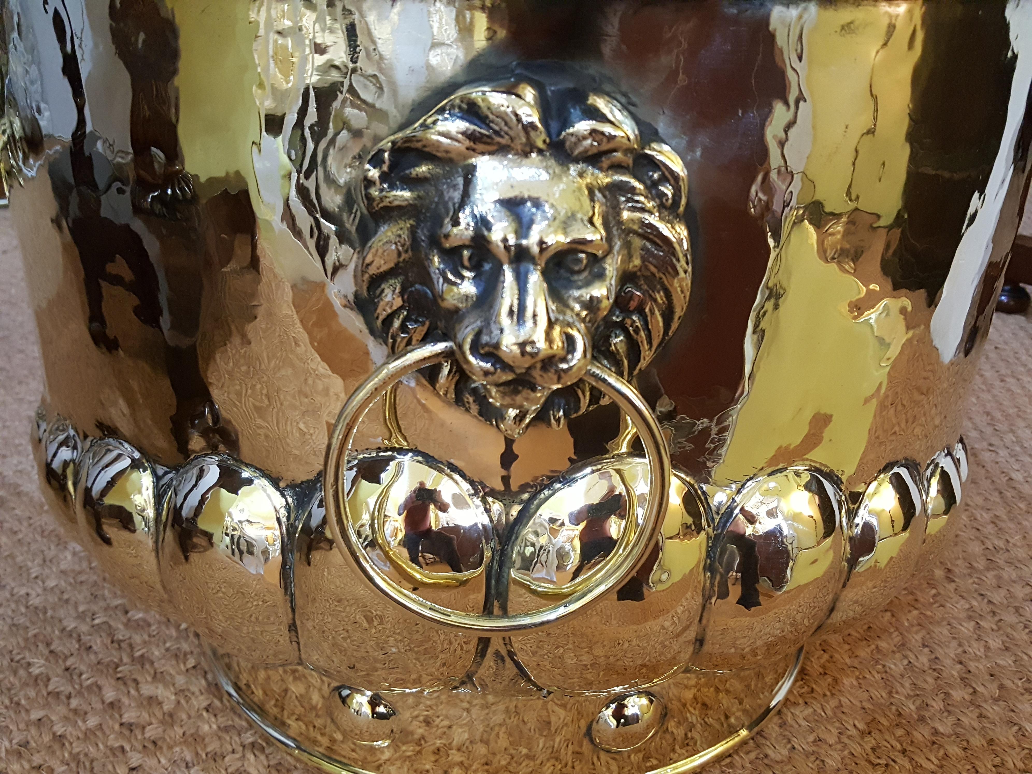 Victorian brass log bucket with lion mask handles, waved gadrooning and button decorated base.