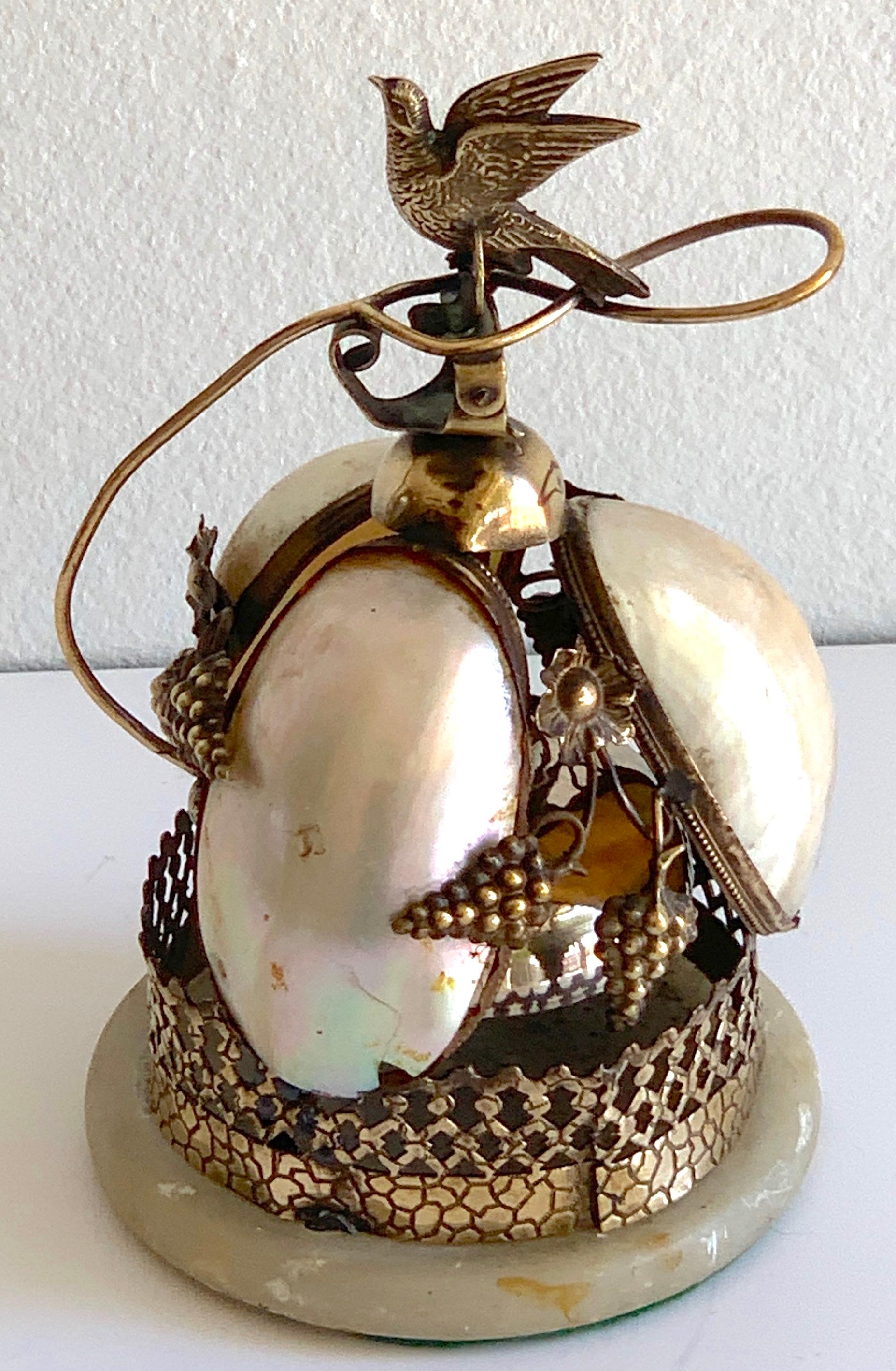 Victorian Brass & Mother of Pearl Bird Motif Table Bell, With a Flying bird handle above three luminous mother of pearl shells, concealing the steel bell, raised on a circular marble base.
Professionally Polished Brass, Working order.