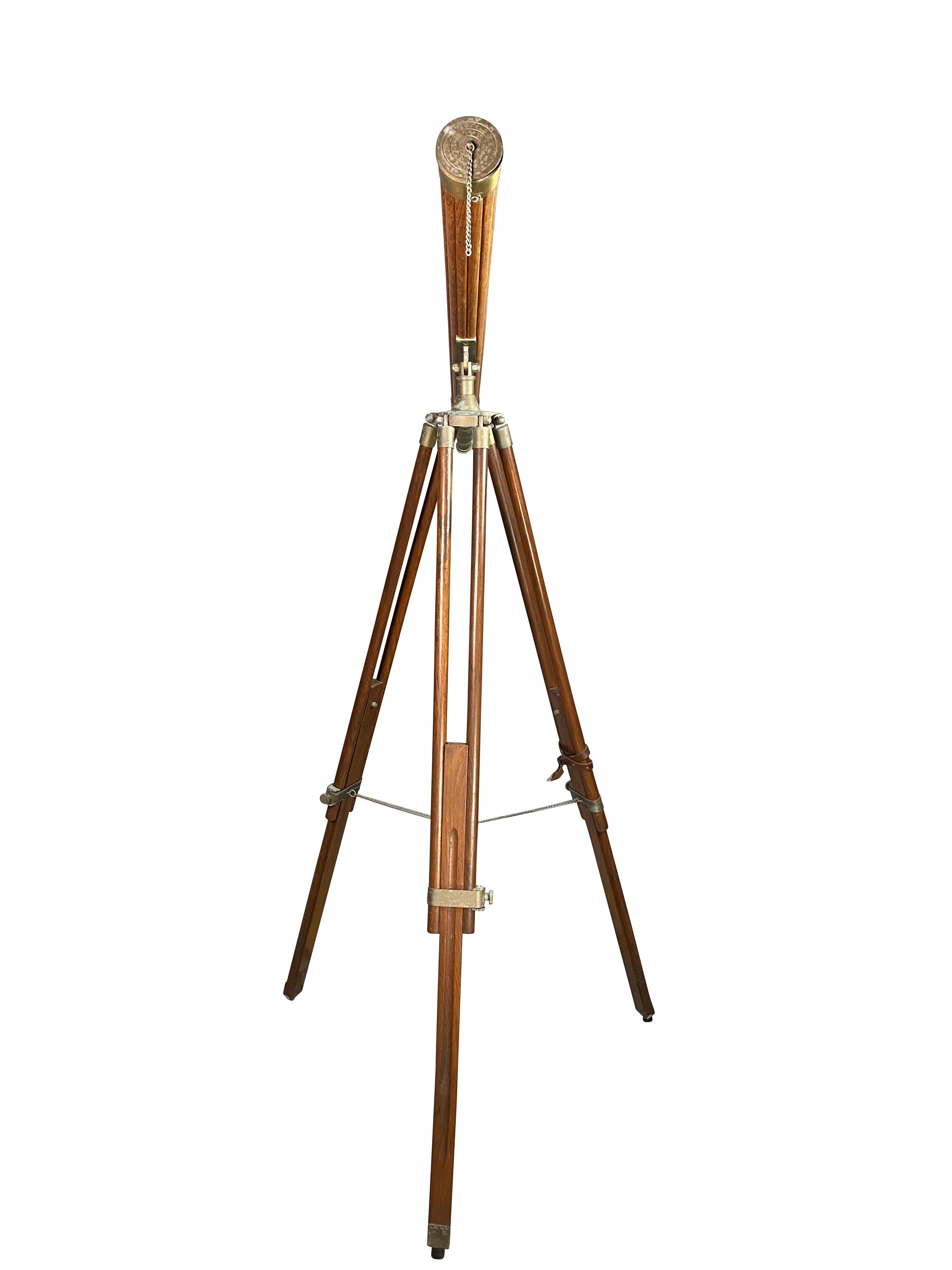 
The telescope with reeded mahogany cover and brass fittings with a tripod folding base.