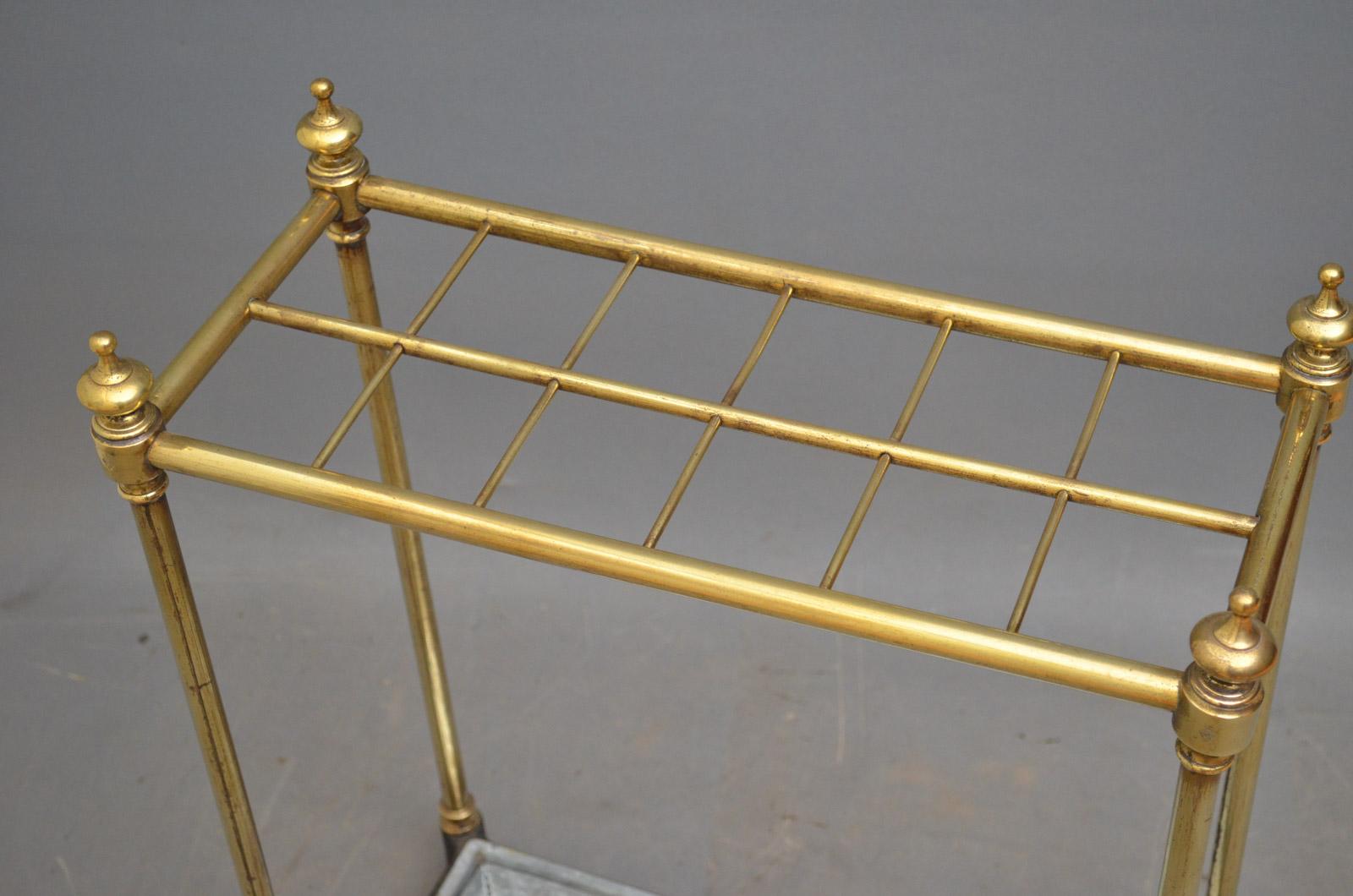 Sn4362, a Victorian brass umbrella stand / stick stand, having 12 sections for umbrellas and walking sticks with finials stamped with date lozenge and removable drip tray, all in fantastic condition throughout, ready to place at home, circa
