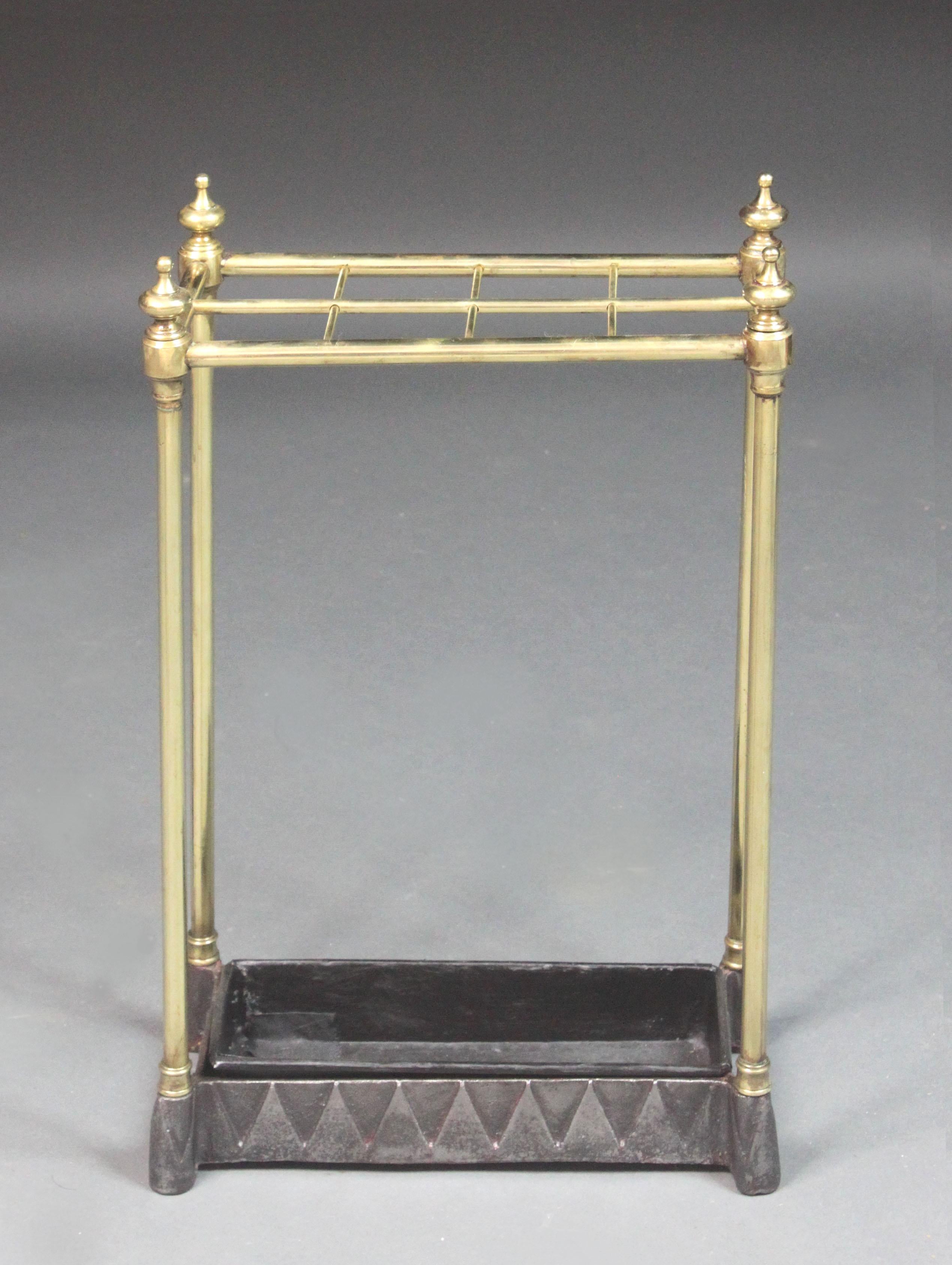 Victorian brass umbrella stand on cast iron base. Recently lacquered & a small hole in the drip pan repaired.
