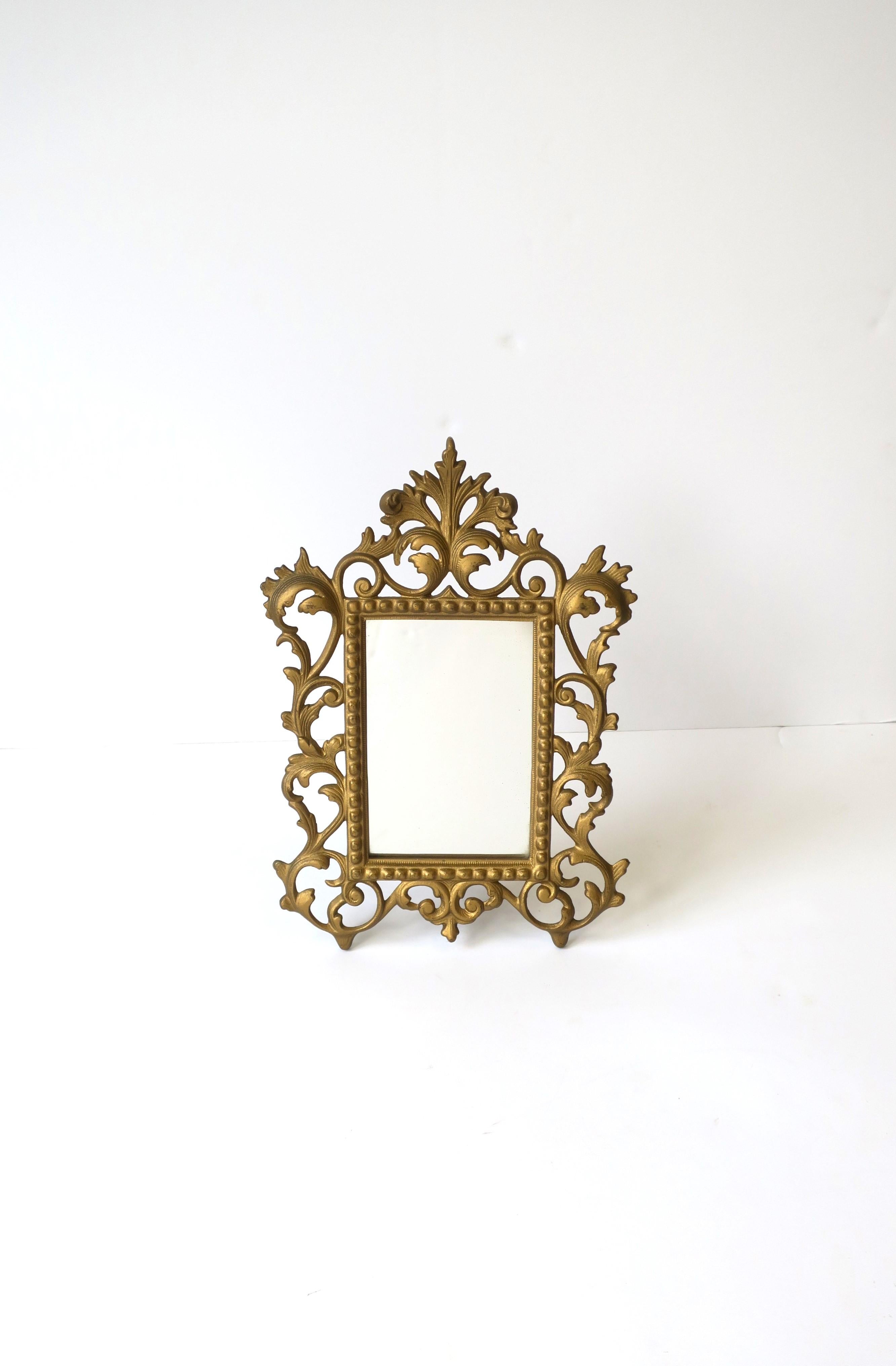 A beautiful antique brass Victorian period table mirror or picture frame, circa early-20th century. Glass is inset into frame, and easily removable to clean. Picture area dimensions: 3.75