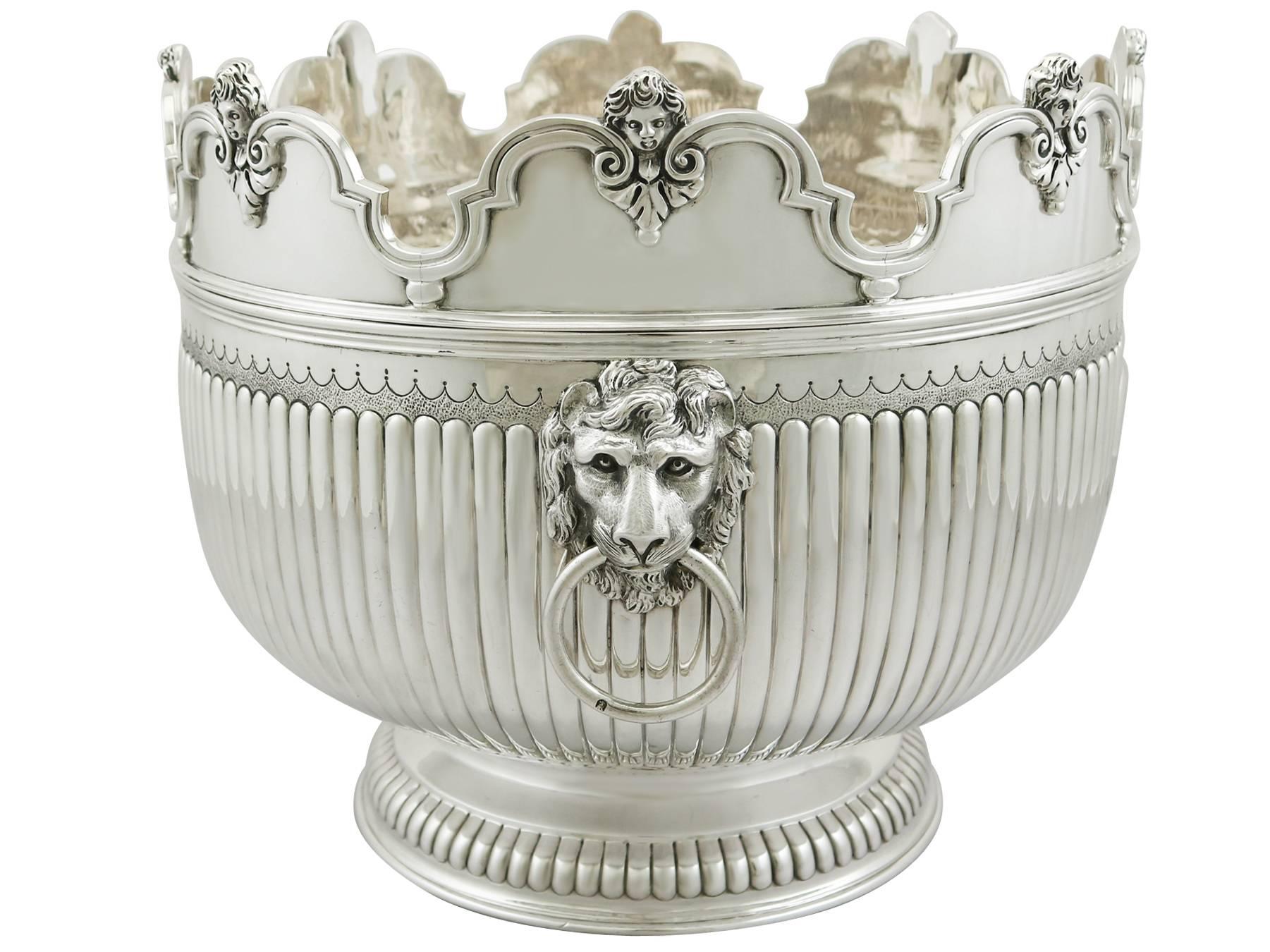A magnificent, fine and impressive antique Victorian English Britannia silver Monteith bowl; an addition to our range of collectable silverware.

This magnificent antique Victorian Britannia standard silver bowl has a large Monteith form onto a