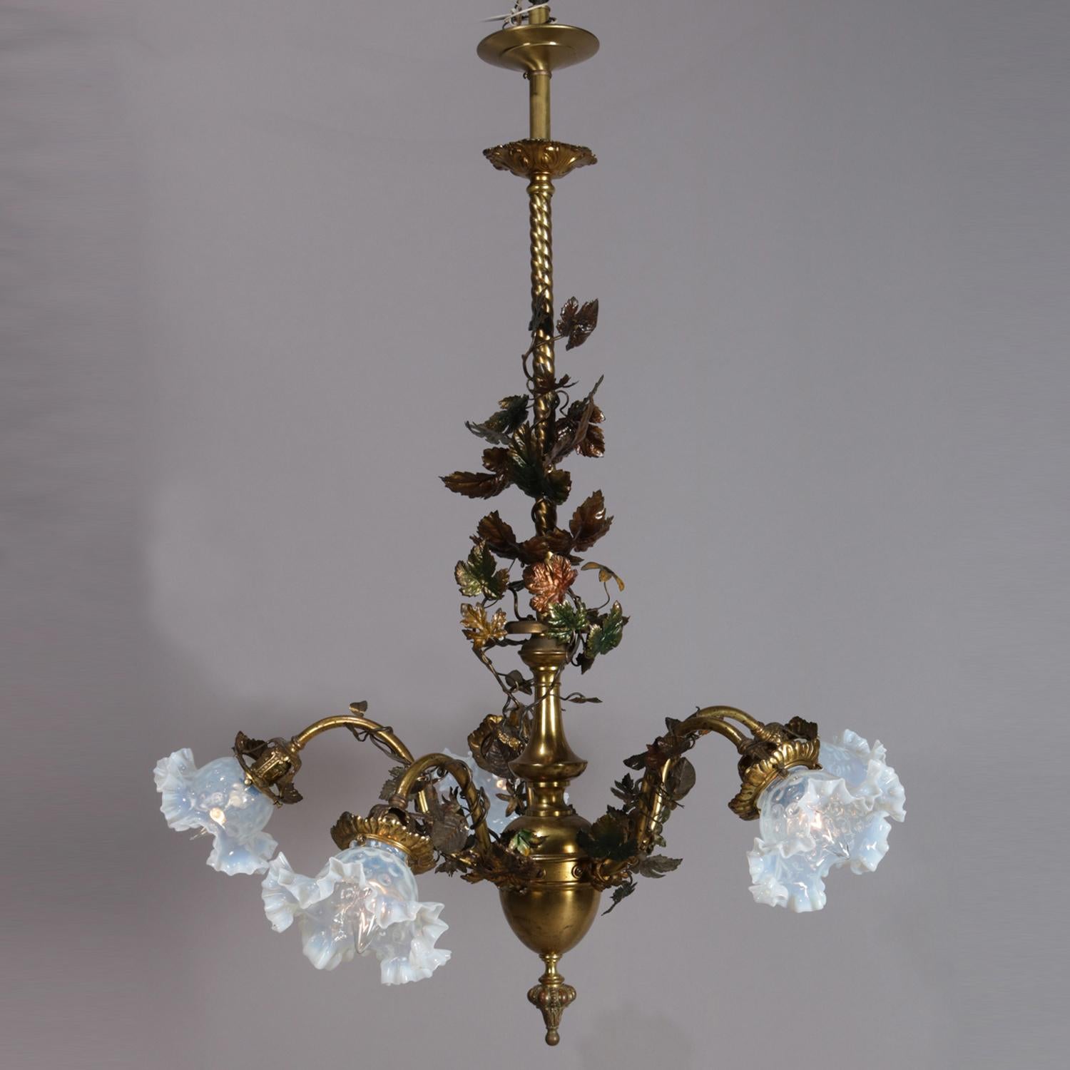 Victorian brass and bronze chandelier features twisted shaft with urn form font having five S-scroll arms terminating in floral form bobeches housing ruffled rim opalescent light shades, all-over decorated with vine and leaf form motif, circa