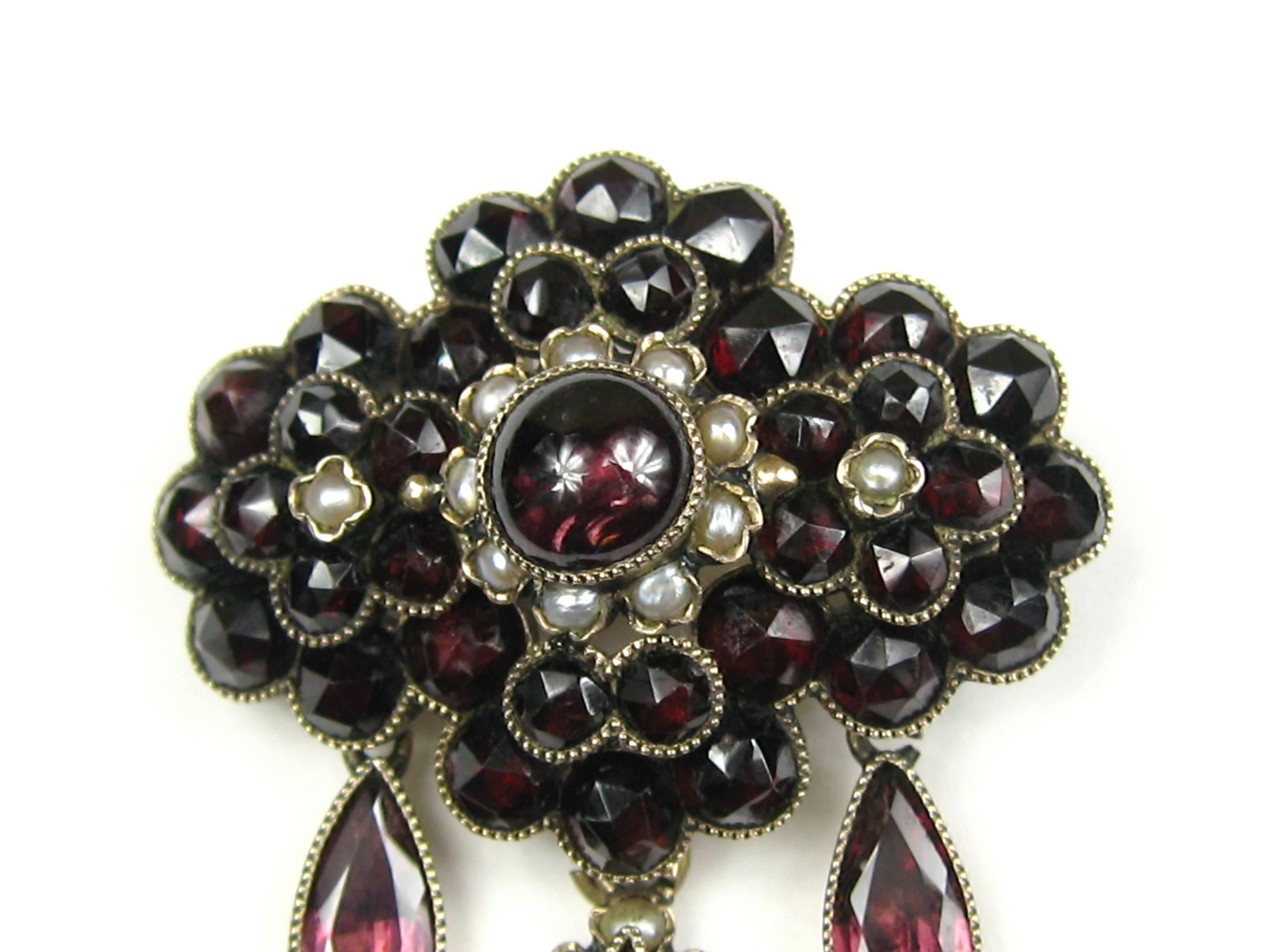 14K Gold Bohemian Garnet & Seed Pearl Brooch Pin. Offered for sale is this truly spectacular Pin. This is one of those rare hard to find Antiques pieces! Center cabochon Garnet as well as bezel set garnets that make up a floral motif. It has 3 Tear