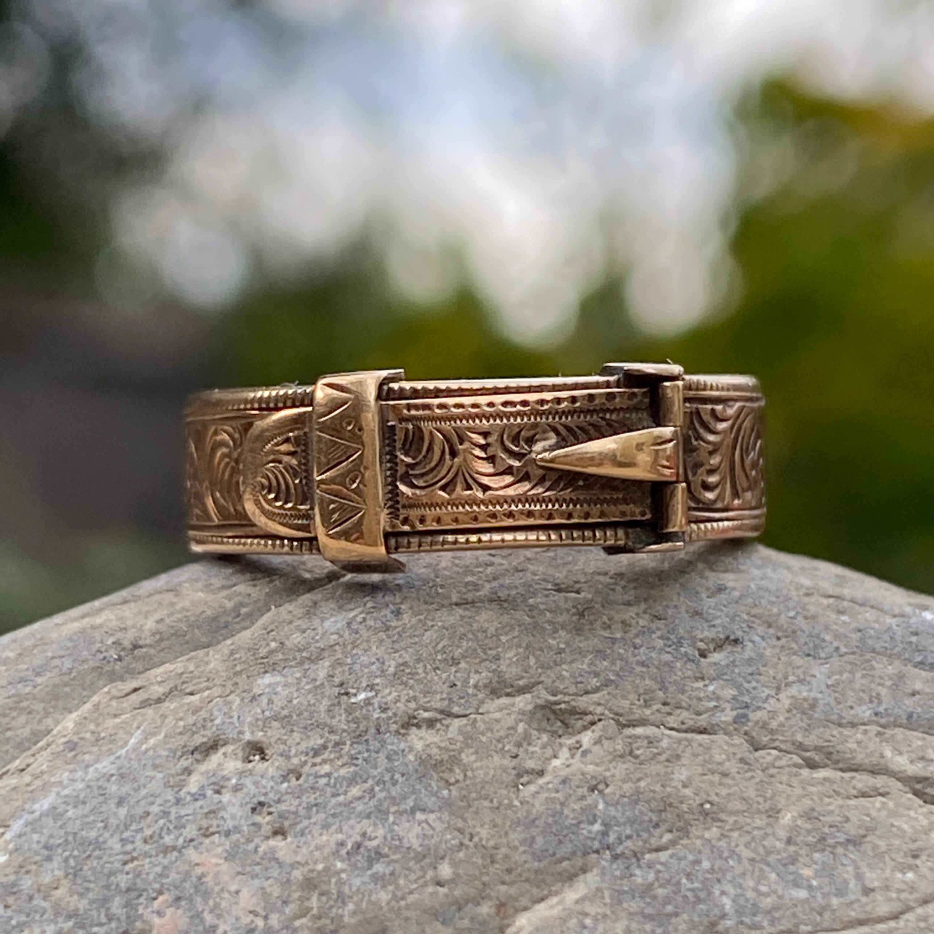 Details:
Super sweet Victorian memorial buckle ring in 14K yellow gold. This sweet engraved, tooled ring opens to reveal a woven hair of a loved one. It is original to the piece, and dates to the mid 1800's. This is a remarkable piece, that opens