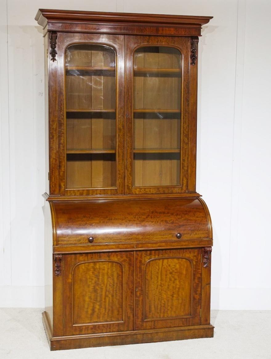 Very handsome piece of classic English furniture in the form of a bureau bookcase with cylinder desk
Look at the patina and finish to the mahogany
Top half is glass fronted to house the books and decorative pieces
Desk section opens out to reveal