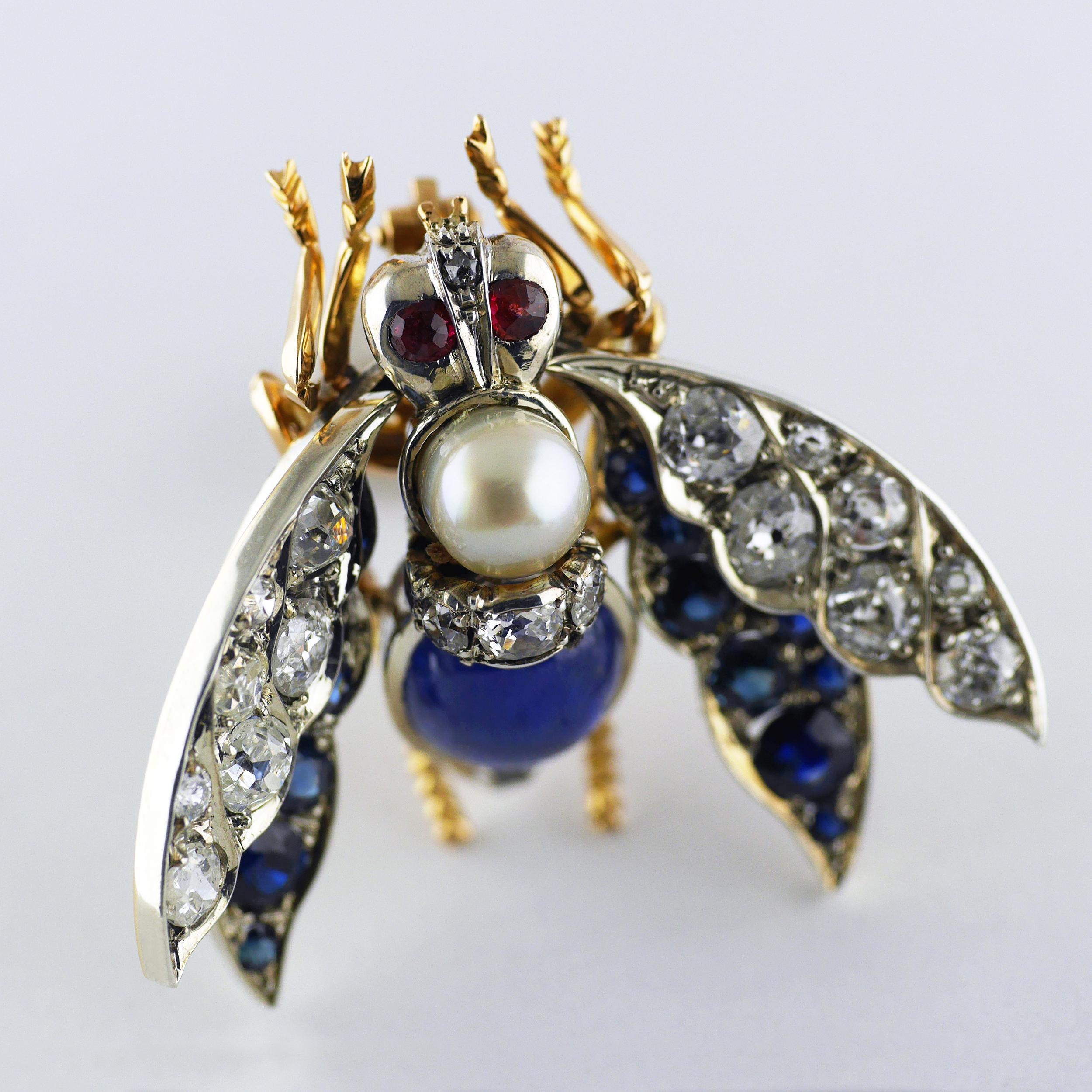 An exceptional, exquisite and well preserved Victorian brooch in the form of a bee with ruby eyes, sapphire and diamond wings, natural pearl and cabochon natural untreated Burma Sapphire.

Mounted in 18ct rose gold and silver set, intricately formed