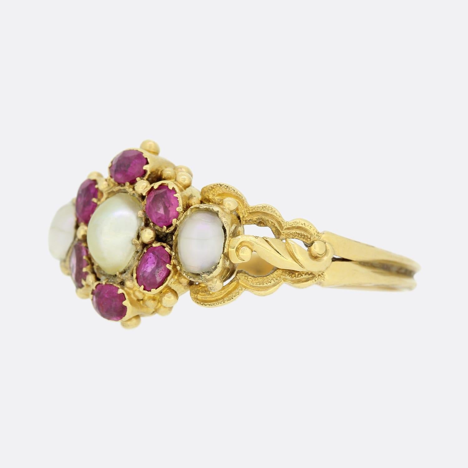 This is a wonderful Victorian 18ct yellow gold cluster ring. The centre of the cluster is a lovely natural pearl that is surrounded by a cluster of 6 old cut rubies. On each side of the cluster there is a further well matched natural pearl. The