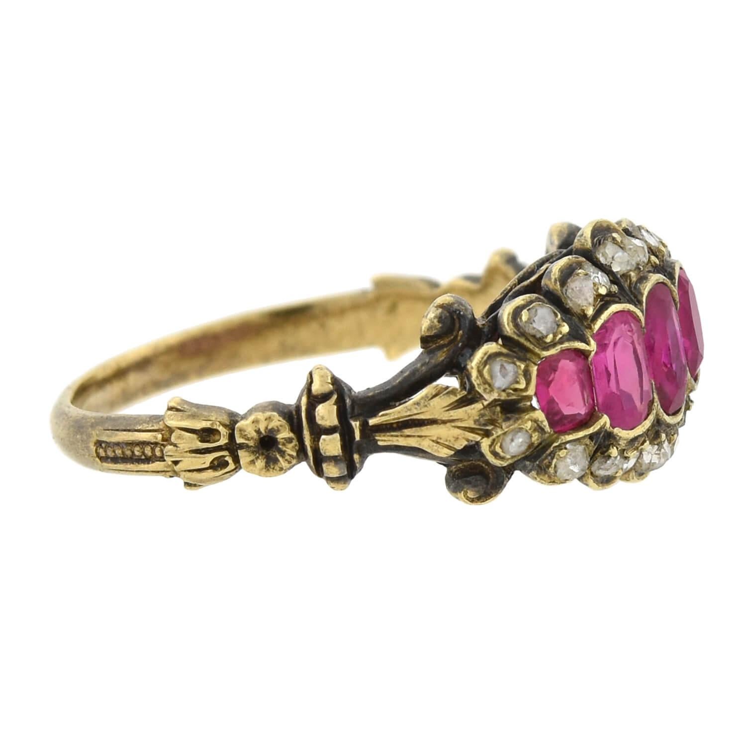 A beautiful gemstone ring from the Victorian (ca1880s) era! This gorgeous piece is crafted in 18kt yellow gold topped with sterling silver and features a beautiful row of luscious rubies and sparkling diamonds across the front. Set along the center