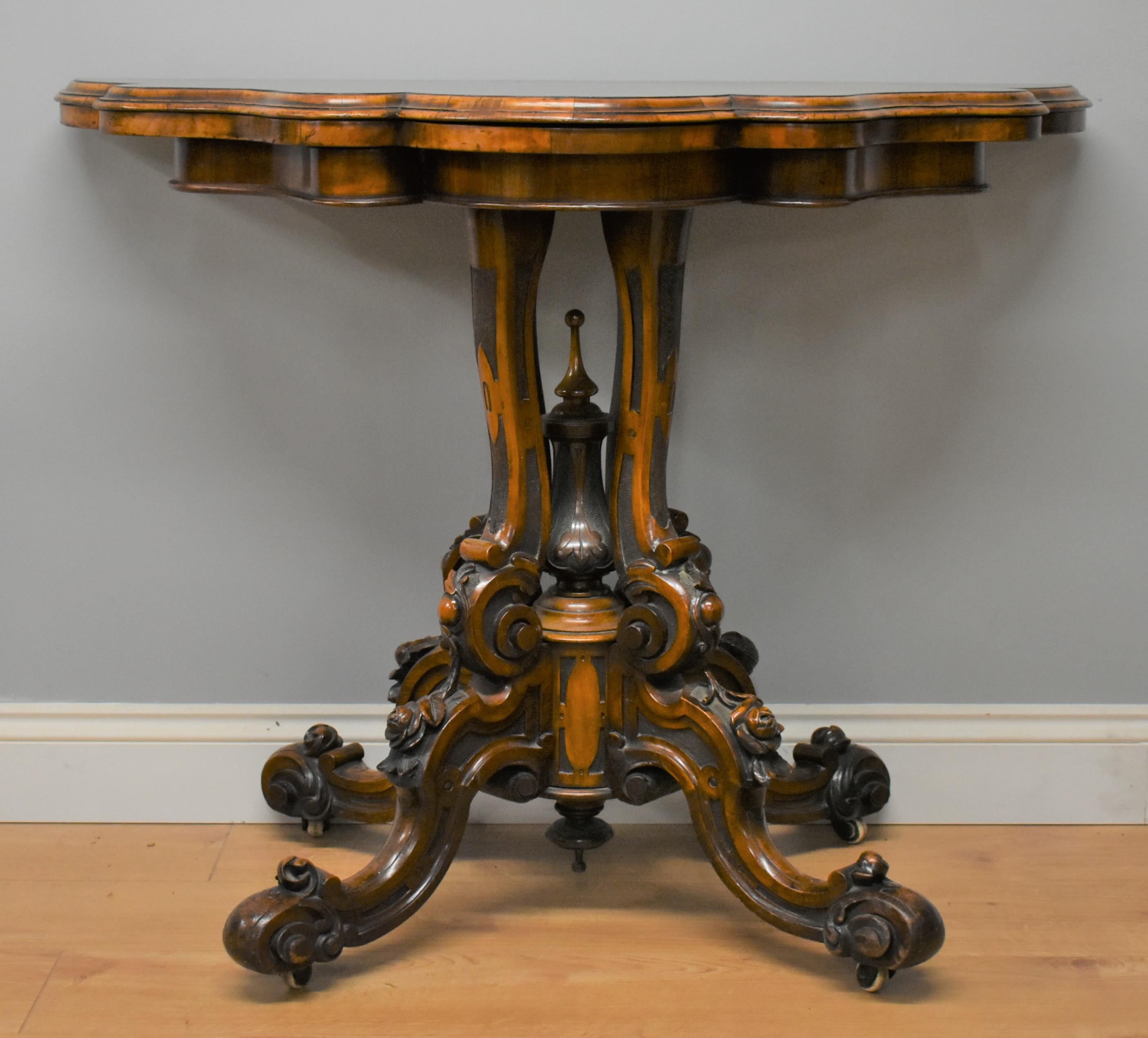 Superb quality Victorian burr walnut card table in good condition, the top is shaped with a lovely carved intricate base. When opened the table reveals its original green tooled leather.
    
