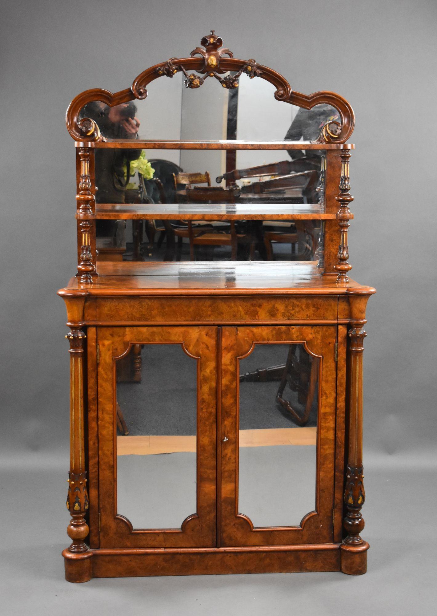For sale is a top quality Victorian burr walnut chiffonier, having a two tiered super structure with a mirror back, above two mirrored doors flanked by columns with gilt decoration, above a plinth base. This piece remains in very good condition,