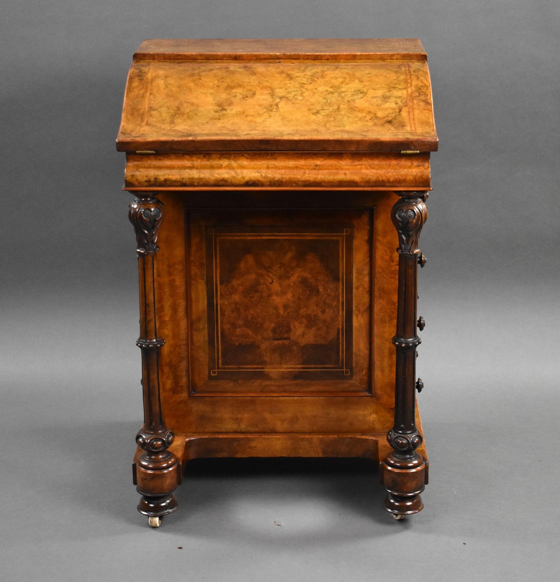 For sale is a good quality Victorian Burr Walnut Davenport of unusual form, the shaped top hinging to reveal a fretwork interior and green leather writing surface, decorated with gold tooling. Having turned and carved columns to the front, with four