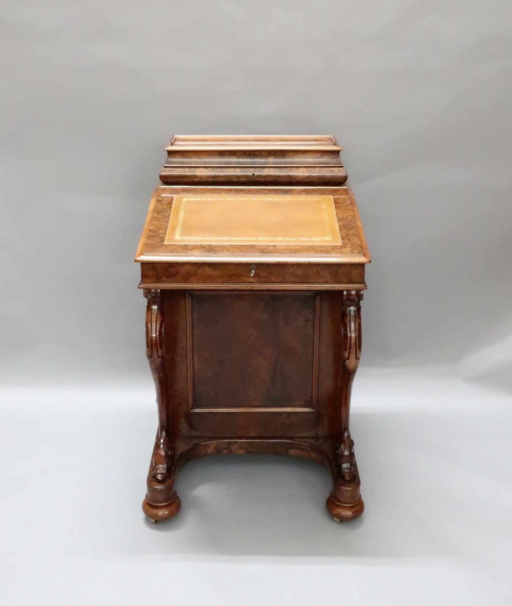 A superb quality Victorian burr walnut Davenport writing desk stood on turned bun feet and shaped carved cabriole legs to the front. The Davenport has very nice quality turned knobs to the drawers with a folding back lid to the top which reveals the