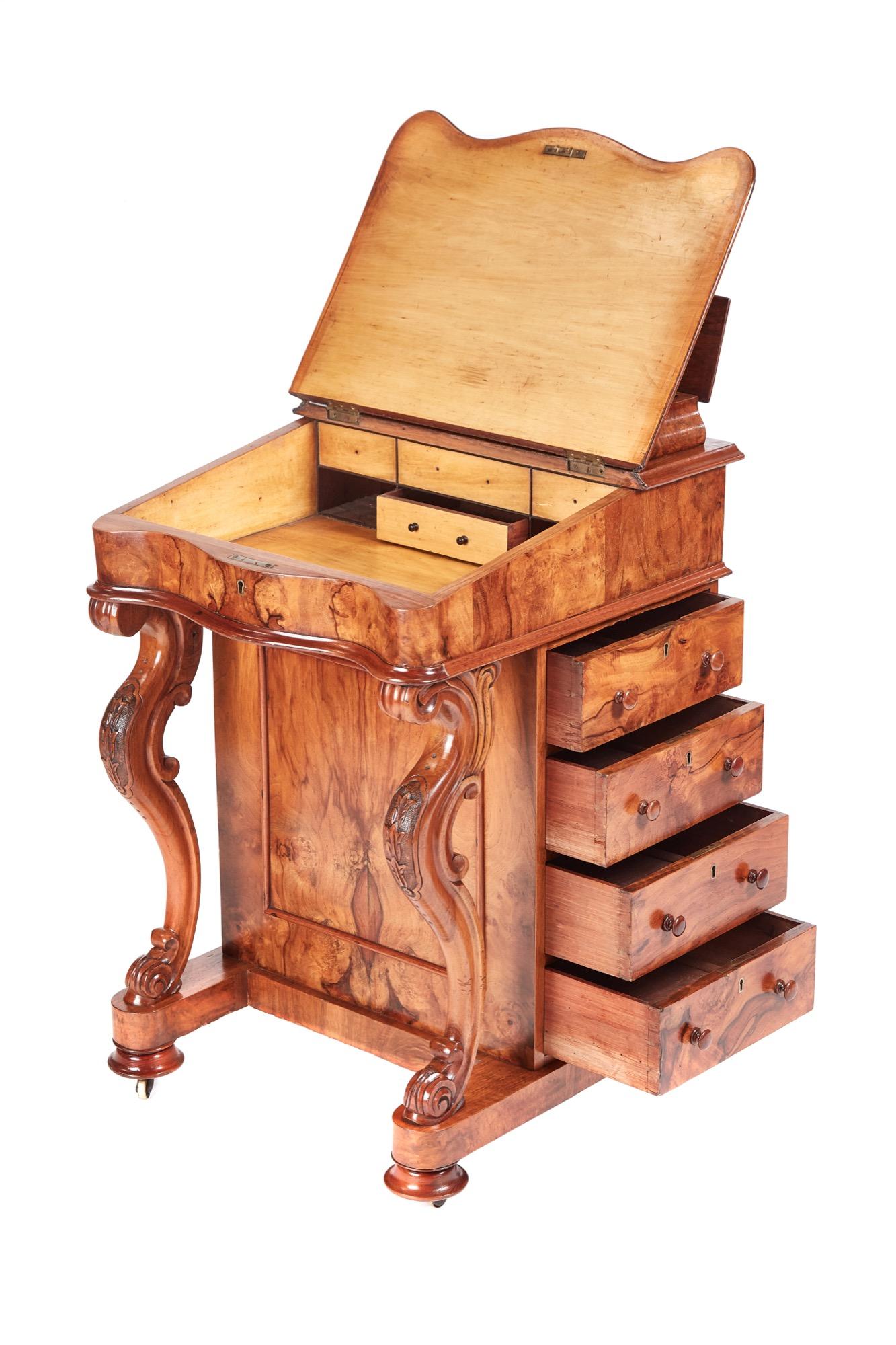 This is a 19th century Victorian antique burr walnut freestanding davenport which has a lift up lid, serpentine shaped writing slope and fitted interior. It boasts a beautiful burr walnut front panel, elegant carved cabriole legs, four opening