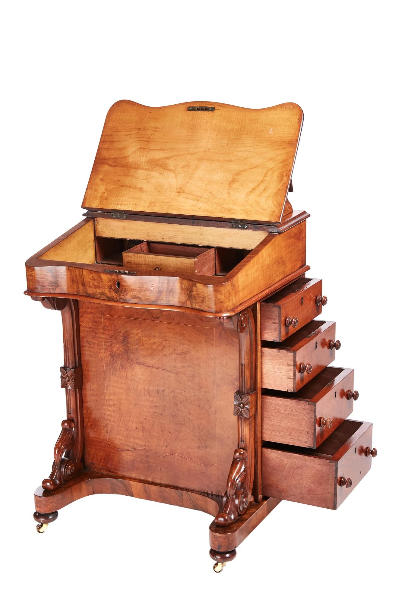 Victorian burr walnut inlaid Davenport. The lid lifts to reveal a lovely fitted interior, it has a serpentine front with carved supports. The right hand side has four drawers with original knobs, the left side has four false drawers with original