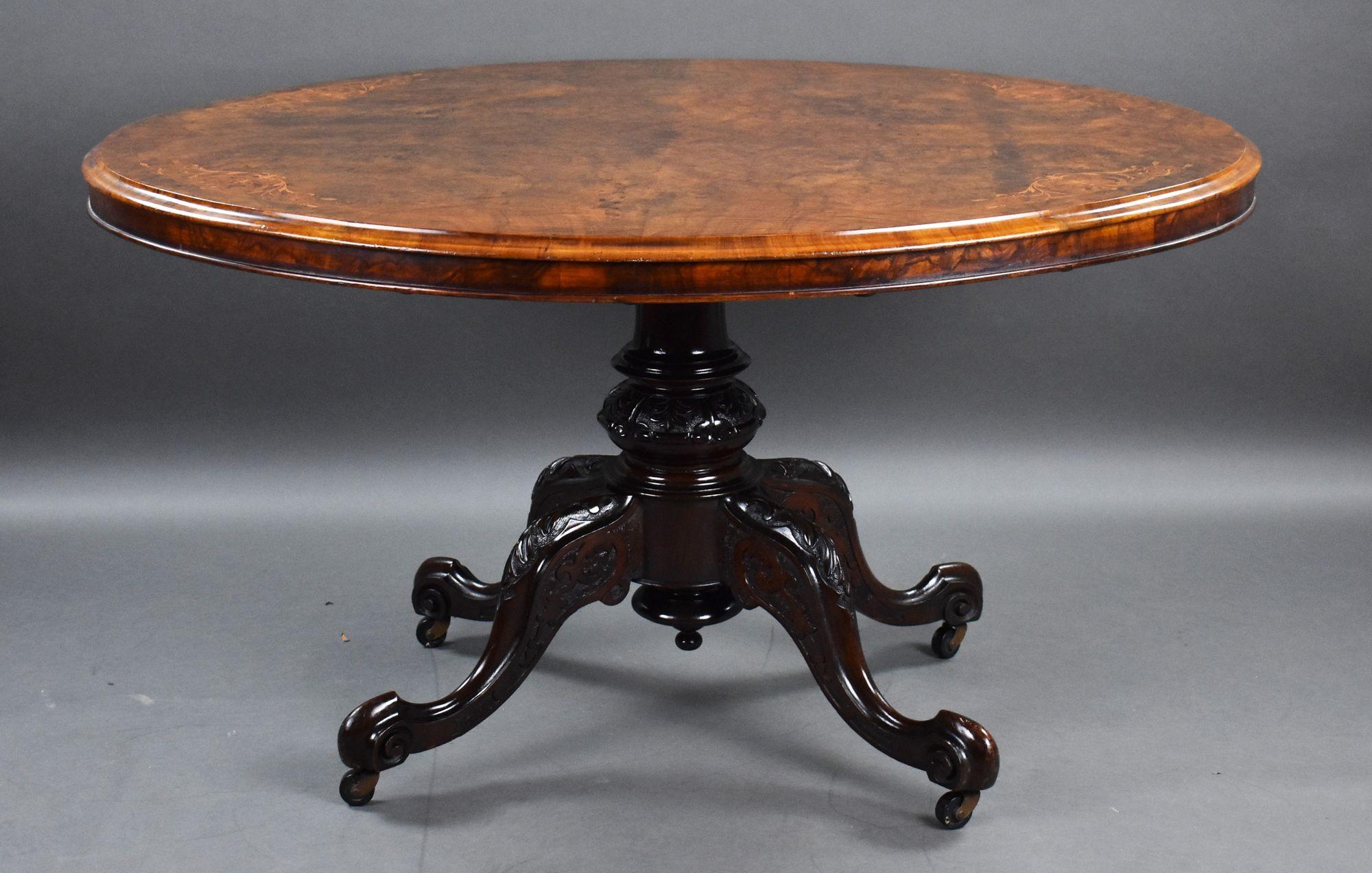 For sale is a good quality Victorian burr walnut inlaid oval dining table, the well figured top, intricately strung and inlaid, above a turned and carved base standing on elegant cabriole legs raised on castors. The table remains in very good