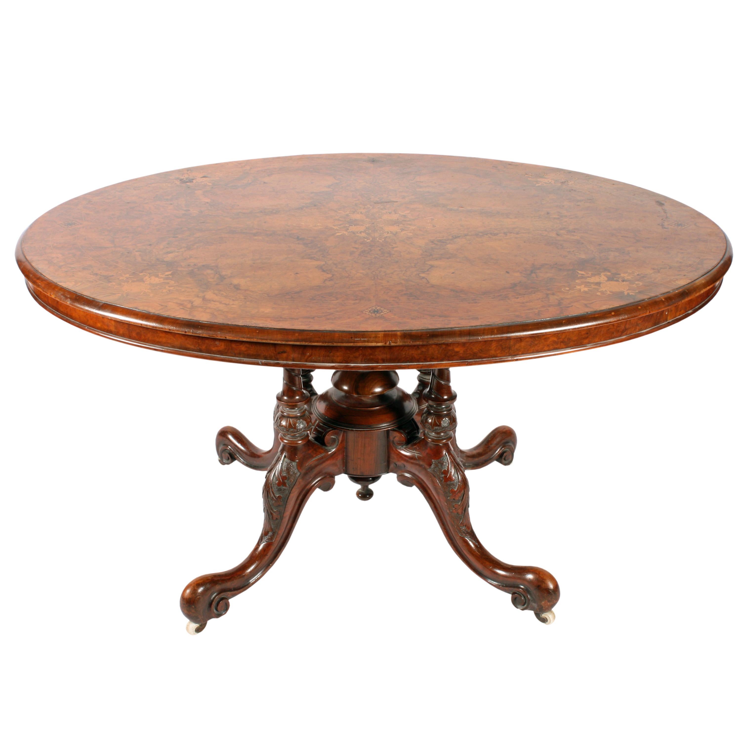 A 19th century Victorian burr walnut quarter veneered oval breakfast or loo table.

The table stands on a quadruped base, the top is box wood inlaid with panels of marquetry and Tunbridge inlay.

The base has four carved walnut cabriole legs