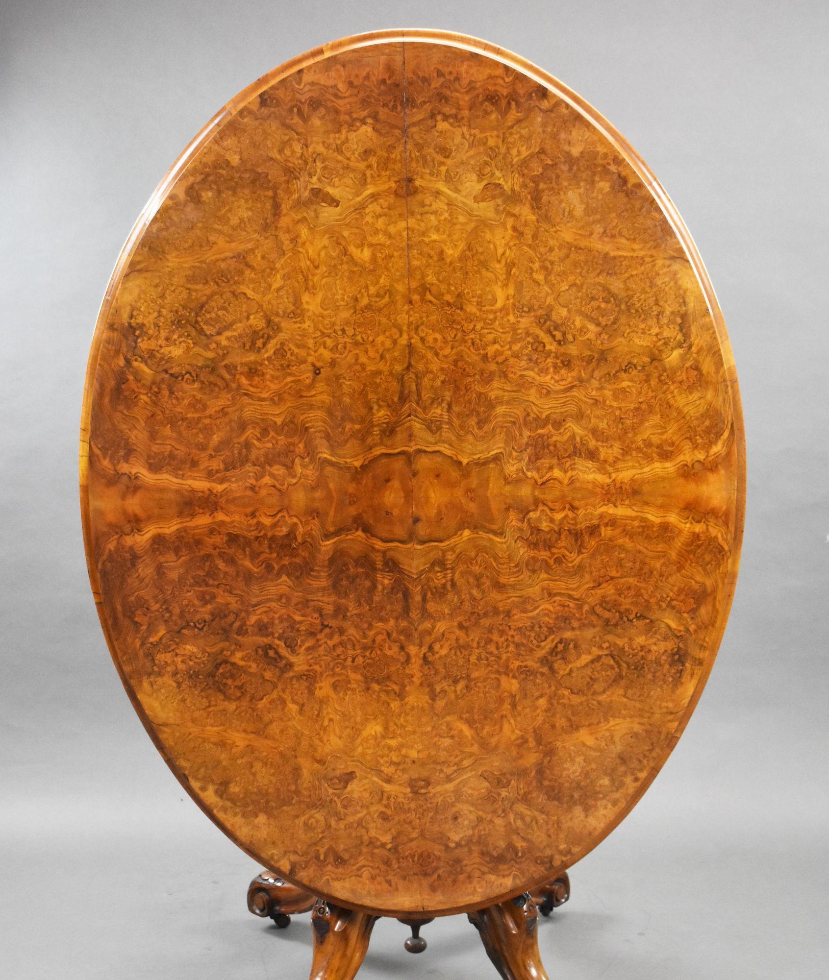 For sale is a Victorian burr walnut oval loo table, having a quarter veneered tilt top, over a carved column and quadruped cabriole legs, raised on castors. This piece remains in very good condition, showing minor signs of wear commensurate with age