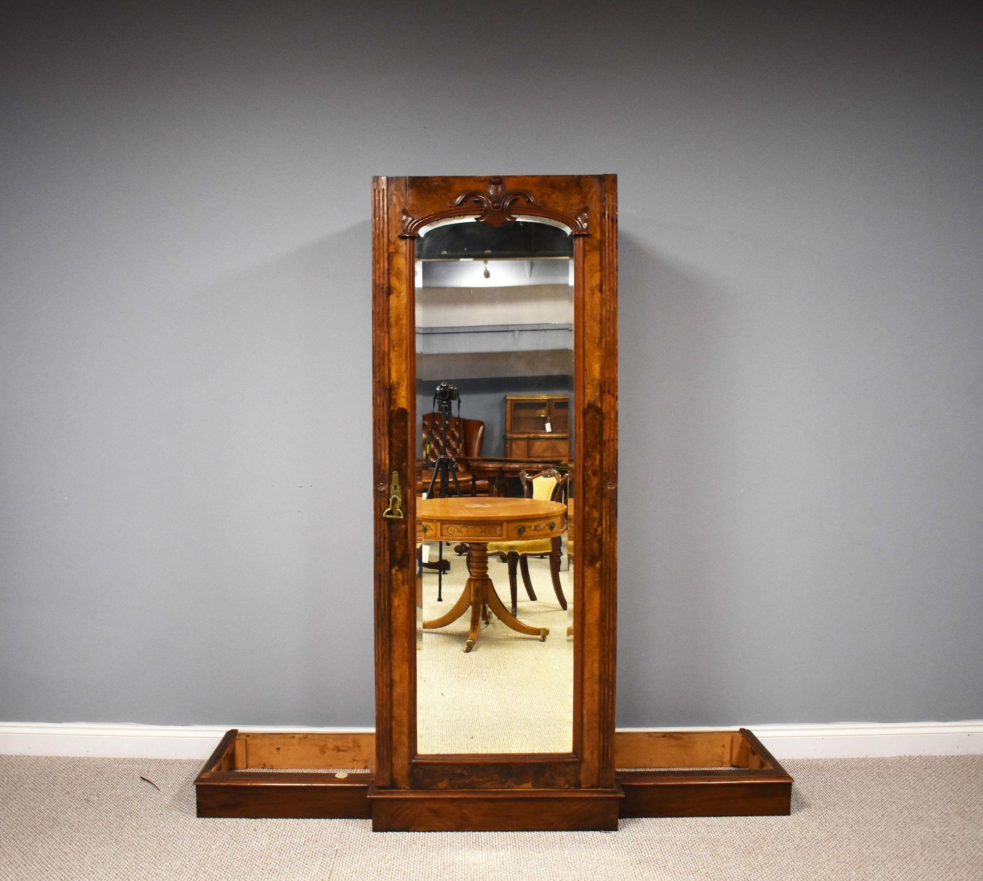 For sale is a good quality Victorian burr walnut breakfront wardrobe by Trapnell & Gane of Cardiff, having a stepped and flared cornice with a carved pediment, above a single mirror door to the centre, opening to a fitted interior comprising drawers