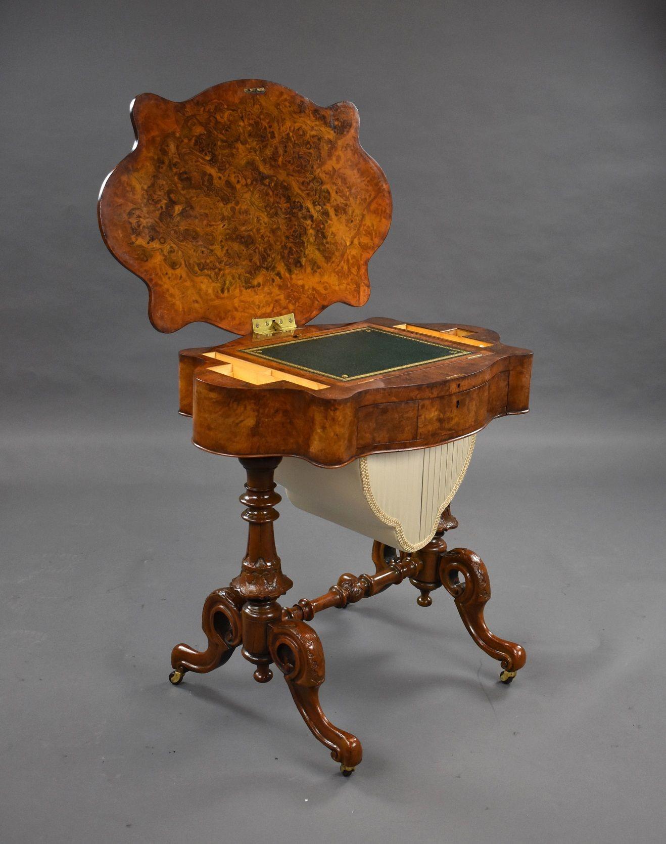 Victorian antique burr walnut work table, the shaped burr walnut lift up top, opening to reveal a green leather writing slope and fitted interior above frieze drawer and storage compartment below, raised on carved taper uprights united by a turned