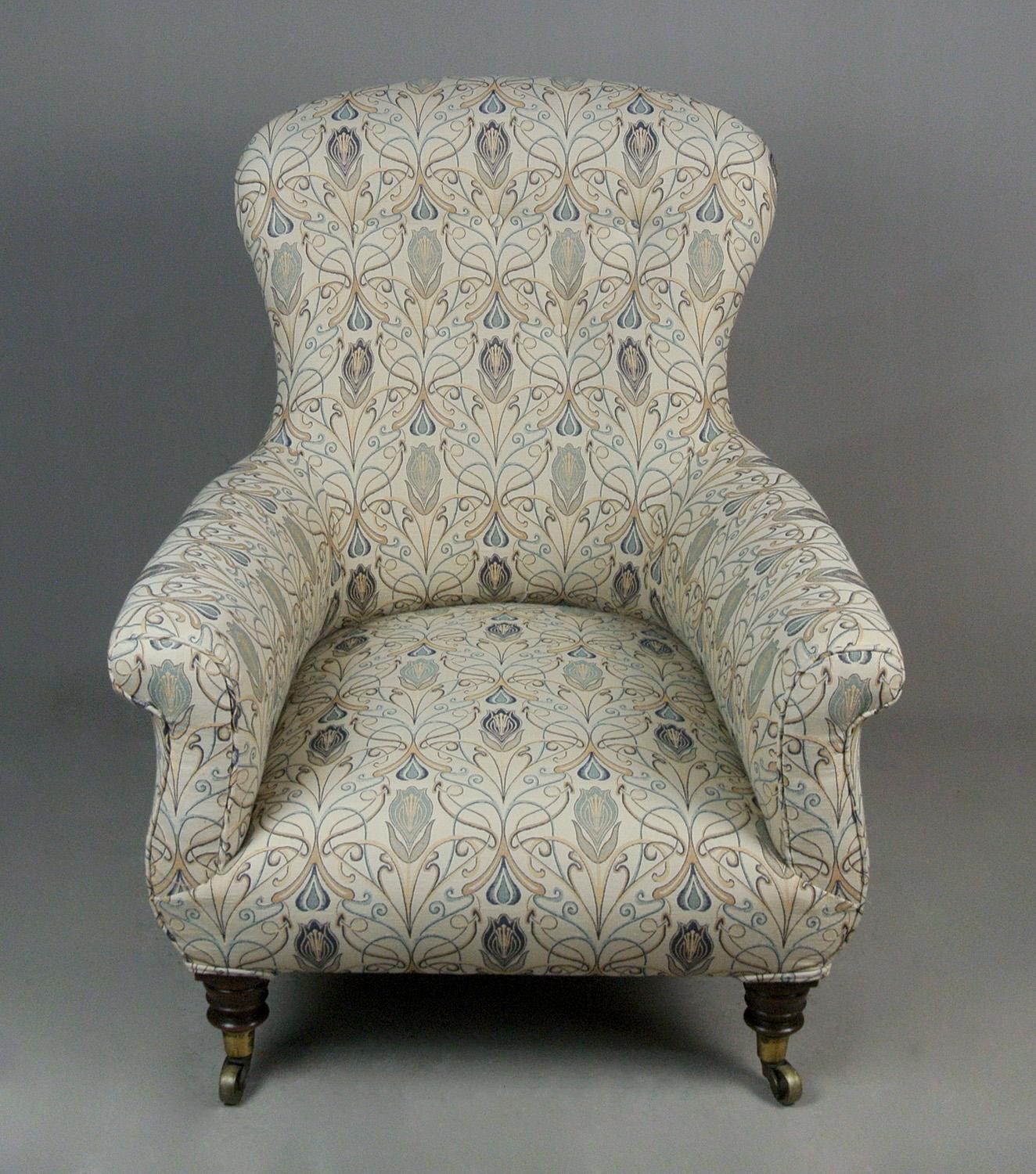Newly upholstered in a heavyweight fabric of William Morris design, this beautiful and very comfortable 19th century arm chair has well turned mahogany front legs and sabre mahogany back legs all fitted with original solid brass large casters.

The