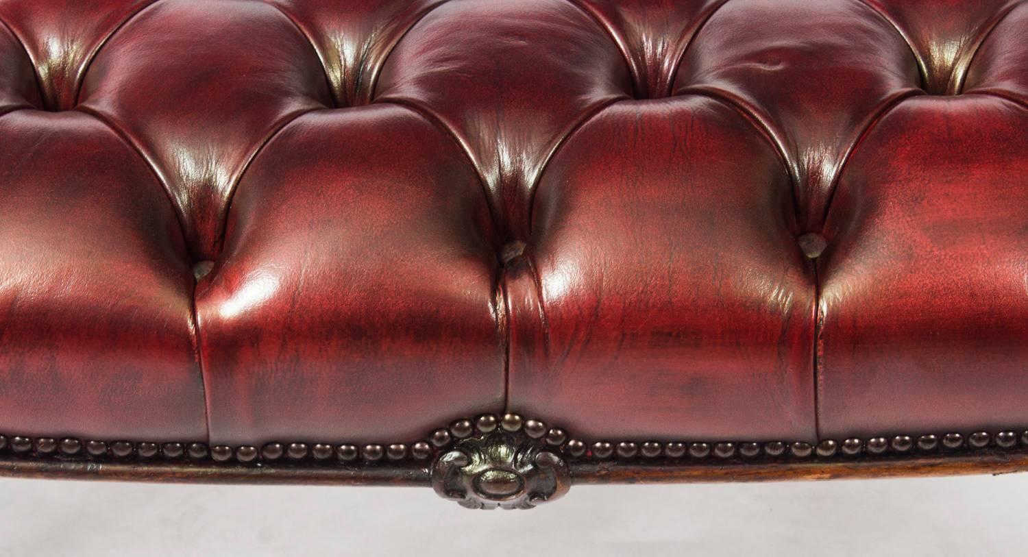 This is a very handsome antique Victorian mahogany buttoned leather stool, circa 1870 in date. 

It features sumptuous buttoned leather upholstery in a beautiful ox blood colour and is raised on four scroll carved cabrile legs.

Condition:
In