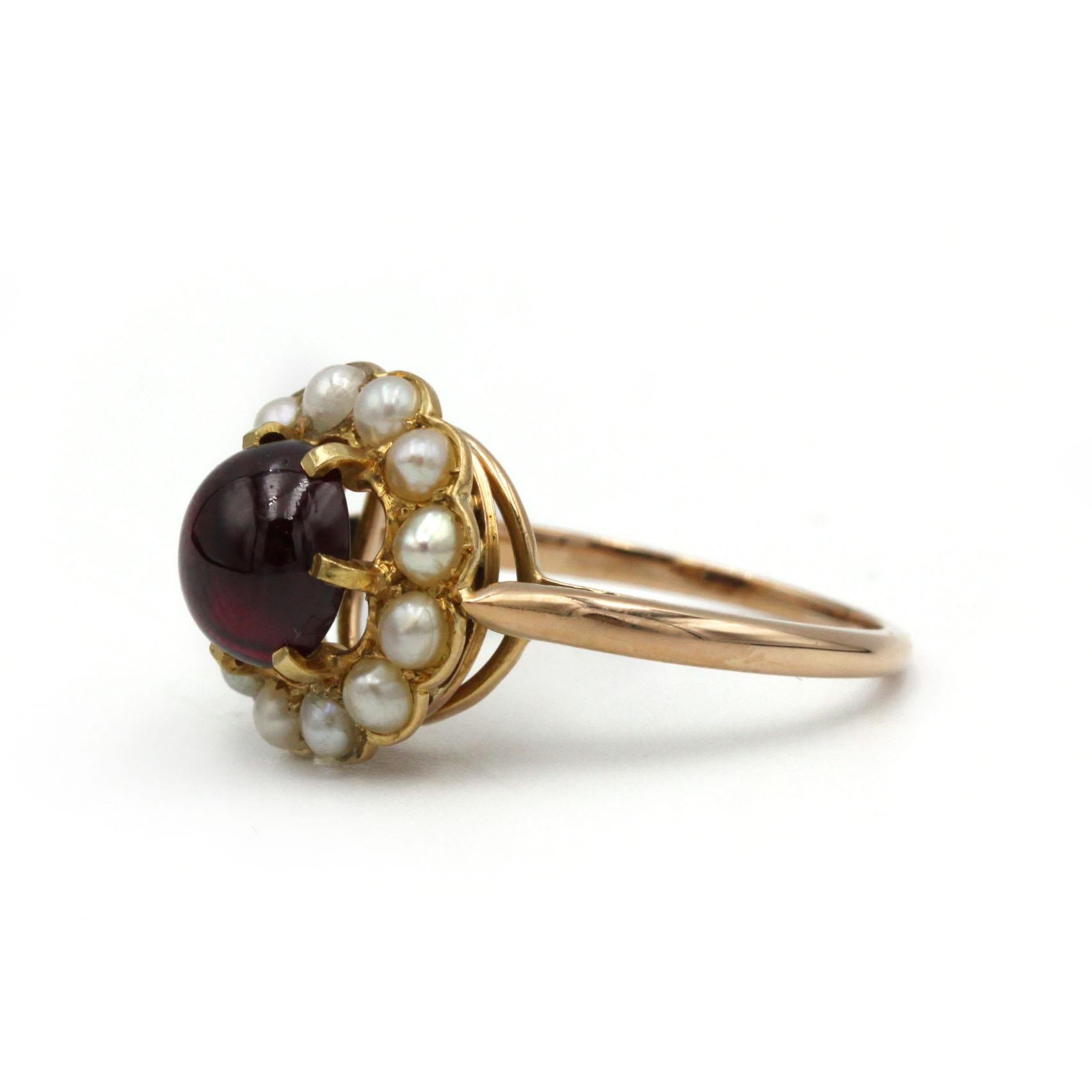Discover the romantic allure of this authentic Victorian cluster ring, expertly handcrafted in rich 18K yellow gold. At its heart sits a lustrous cabochon garnet, lending deep pomegranate hues and smooth, polished elegance. Surrounding the garnet