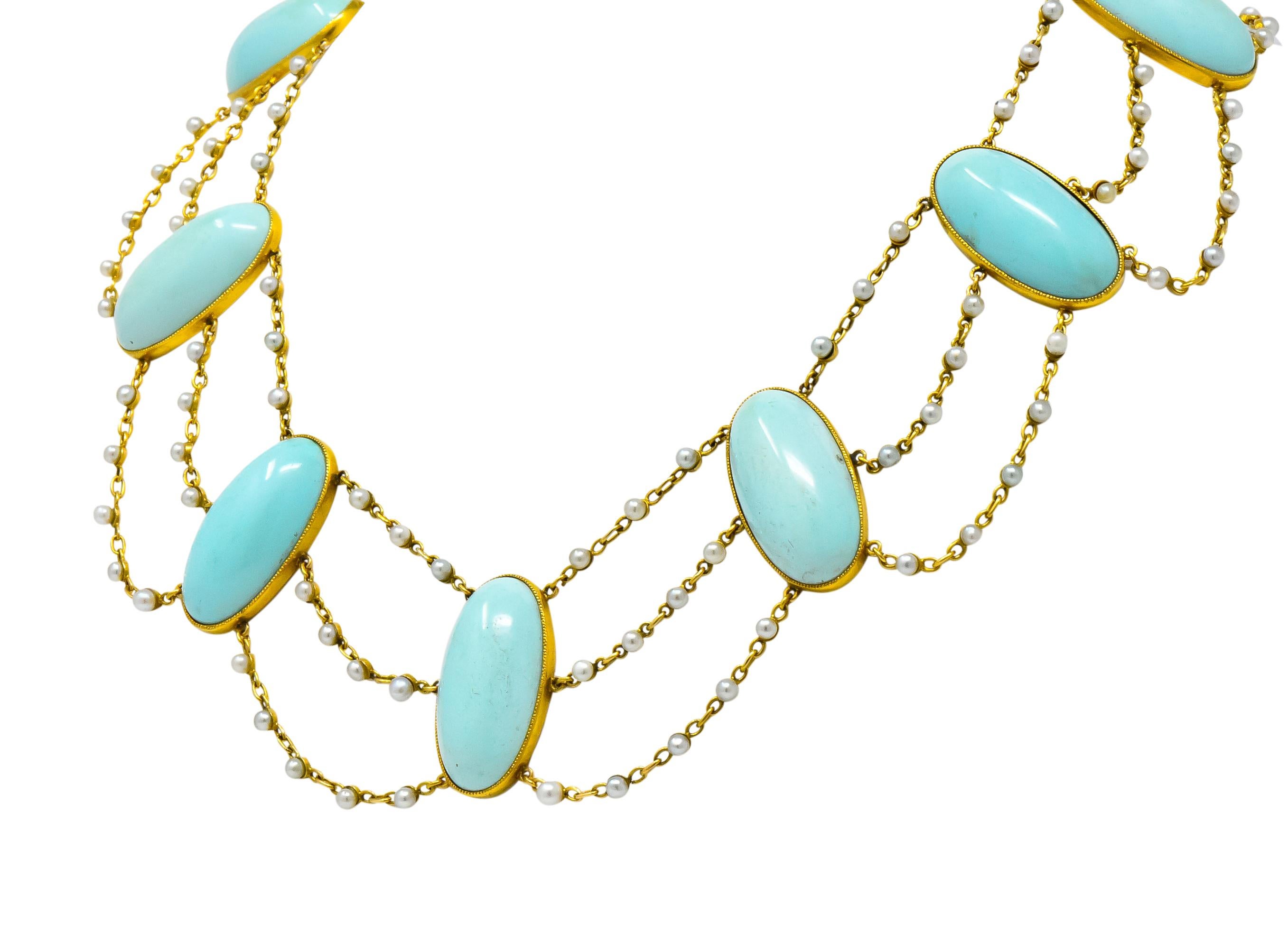 Draping swag motif with ten elongated oval cabochon turquoise stations

Turquoise measuring approximately 28.0 x 13.7 mm, bright soft green blue, matched and bezel set in millegrain gold

Each turquoise connected by three cable style chains set with
