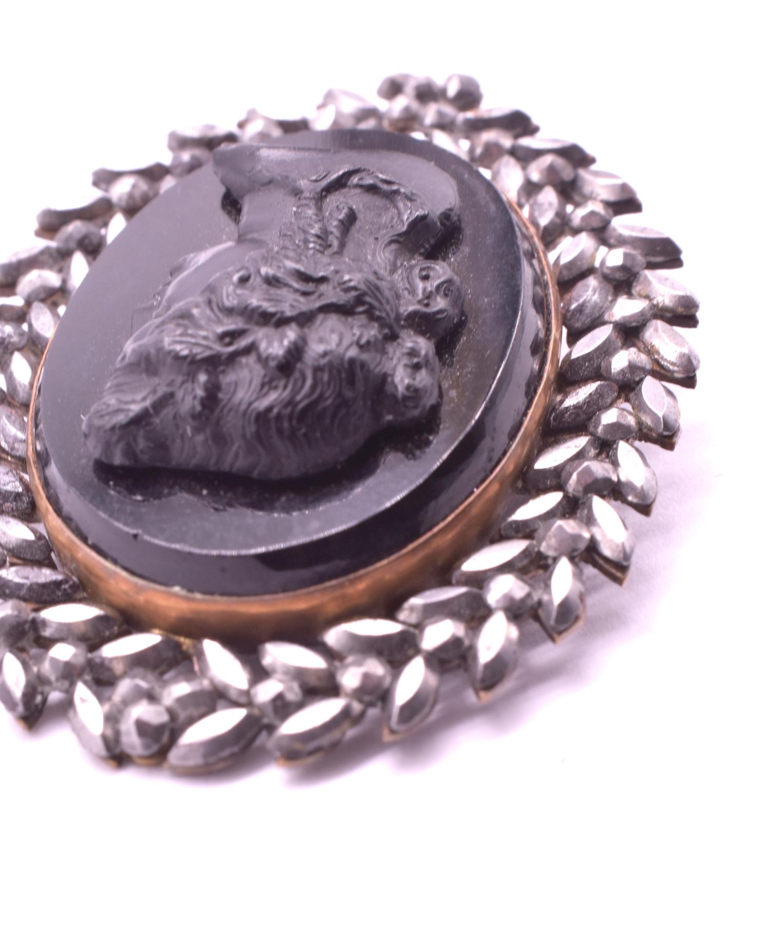 Chunky Victorian brooch of 3 unusual materials unique to the Victorian era; French jet, Whitby jet, and cut steel. The bacchante's features are intricately carved of Whitby jet in matte,  and set on a polished base of French jet with a delicately