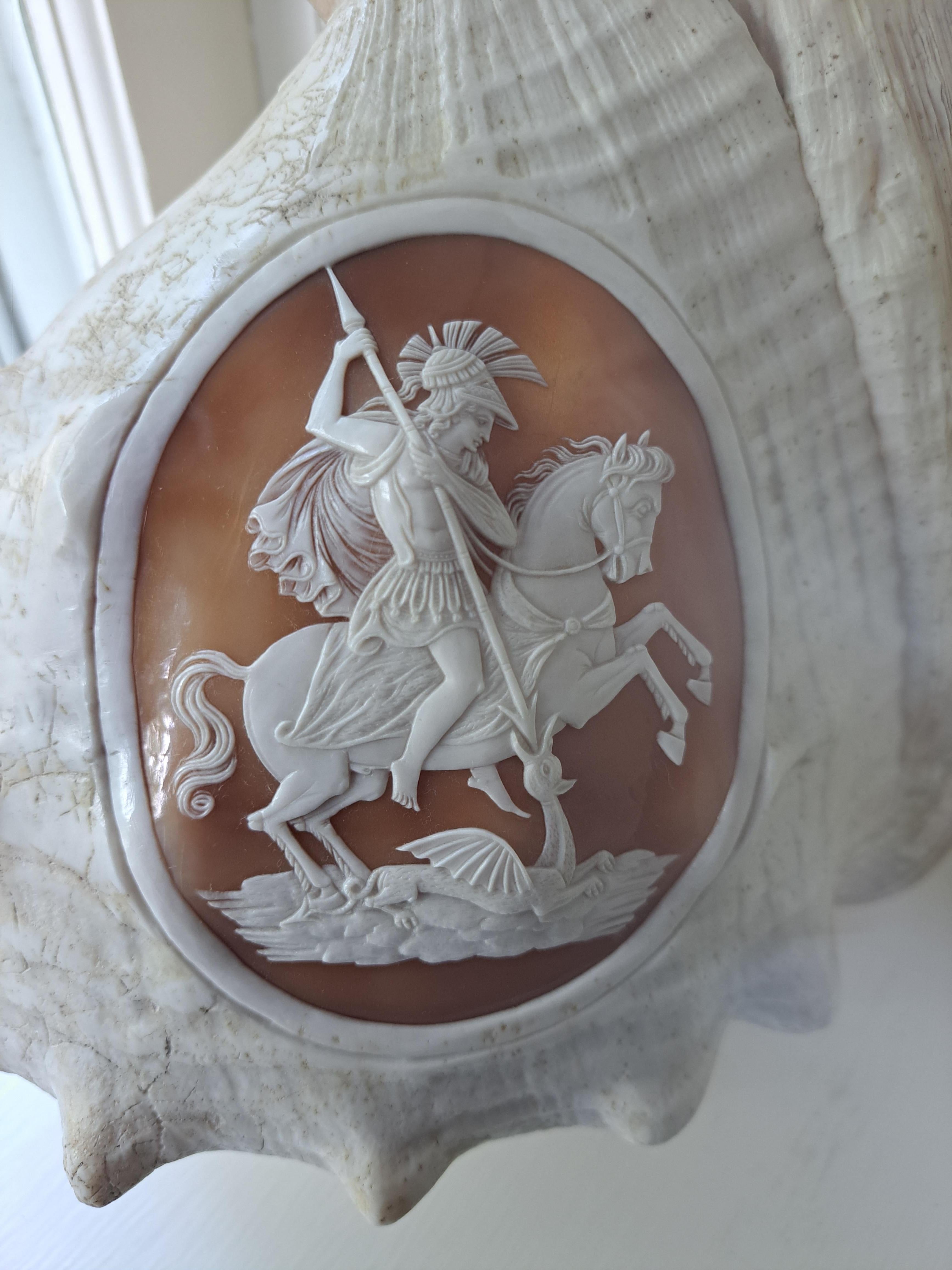 Victorian carved whole conch Shell c1880. Beautiful and rare item to find! This was hand carved in Italy, likely a souvenir of a Grand Tour. The subject of the carving is of St George slaying the dragon.  The carving is well executed and shows