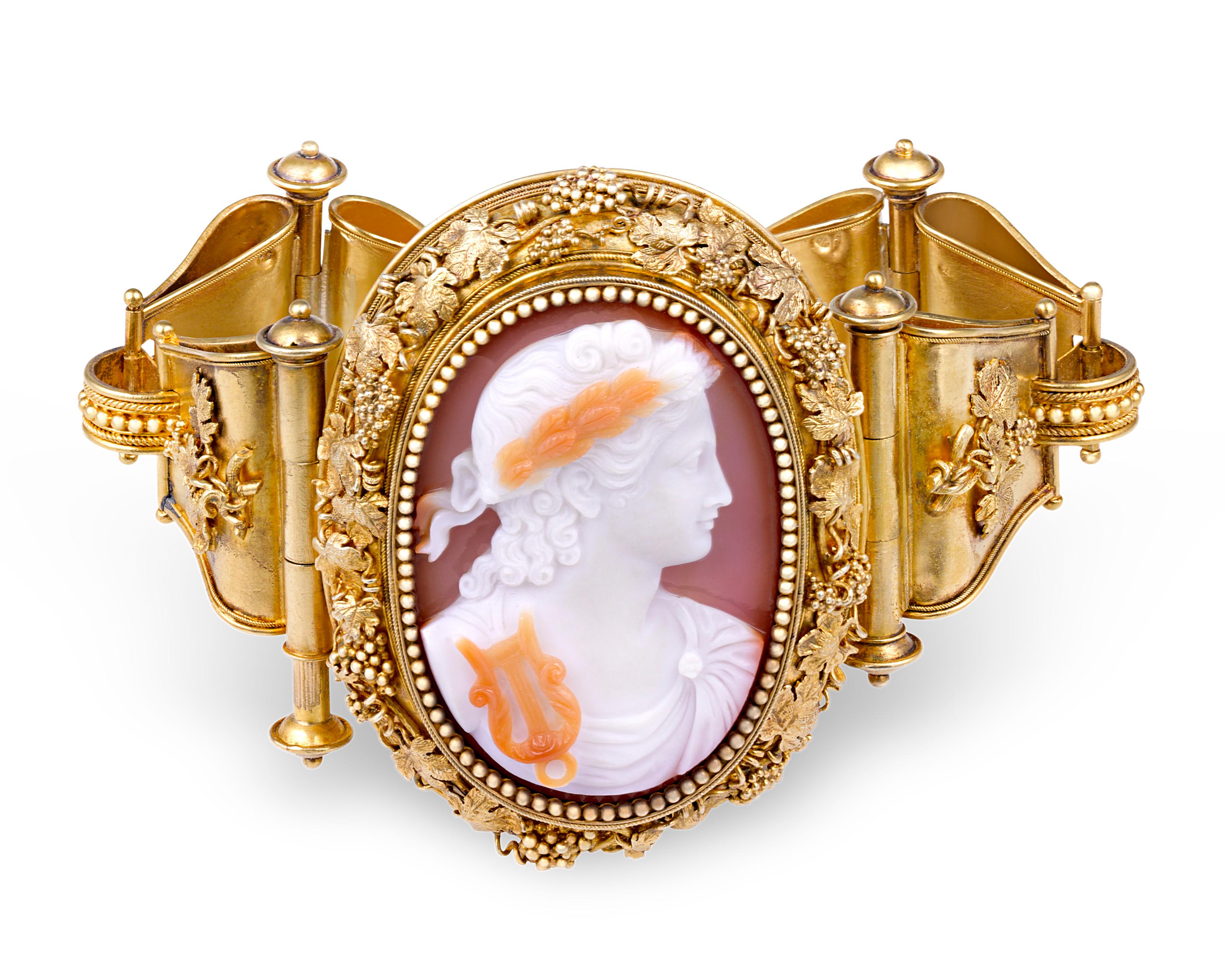 Pure Victorian elegance, this spectacular collection is truly jewelry as art. Four exquisitely carved agate and cornaline cameos fit seamlessly within bold flourishes of 18K yellow gold in this jewelry suite comprising a bracelet, brooch and