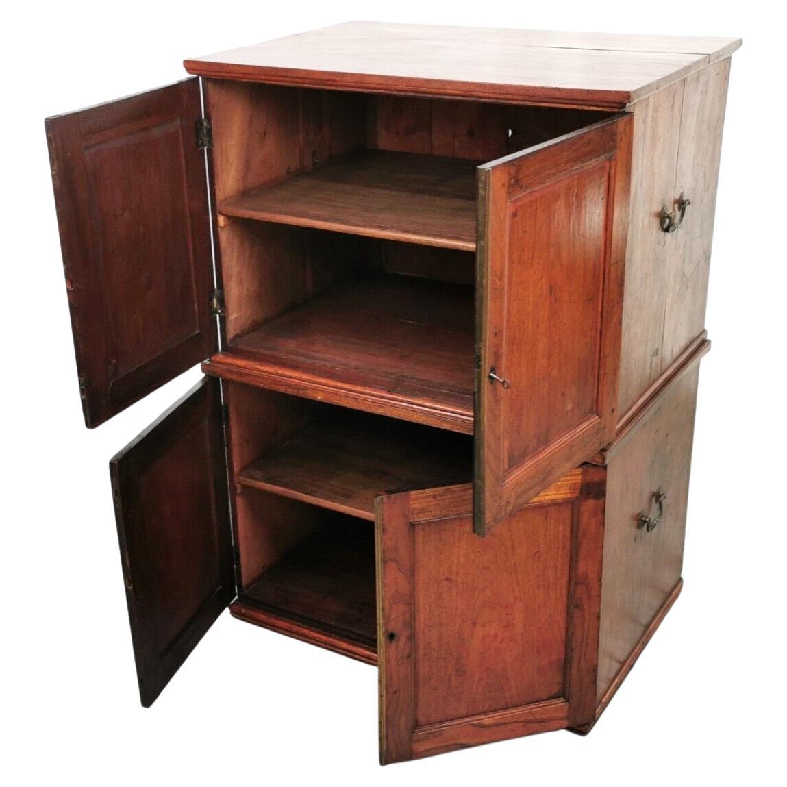 Available for sale is a set of two campaign stackable cupboards with handles to the sides for transportation.

The unit has an oversailing top with moulded edge above a pair of panel-enclosed doors. The door sits over a shelf - size 111cm high,