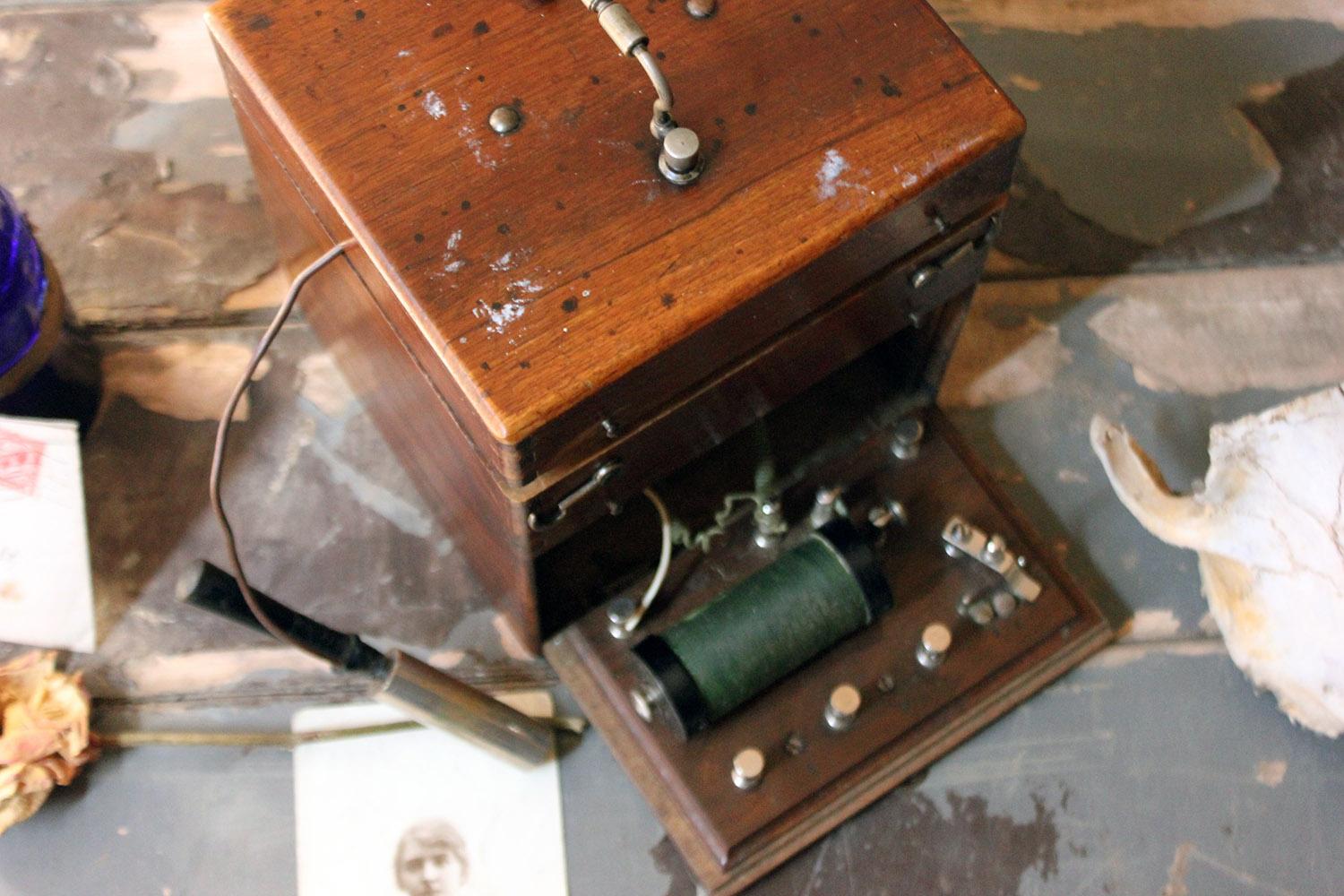 The 19th century electro therapy shock machine, with induction coil with two brass tubes attached to cables through which the current flows, used to treat ‘nervous diseases’ and housed in a good oak Campaign style dovetail jointed box with the