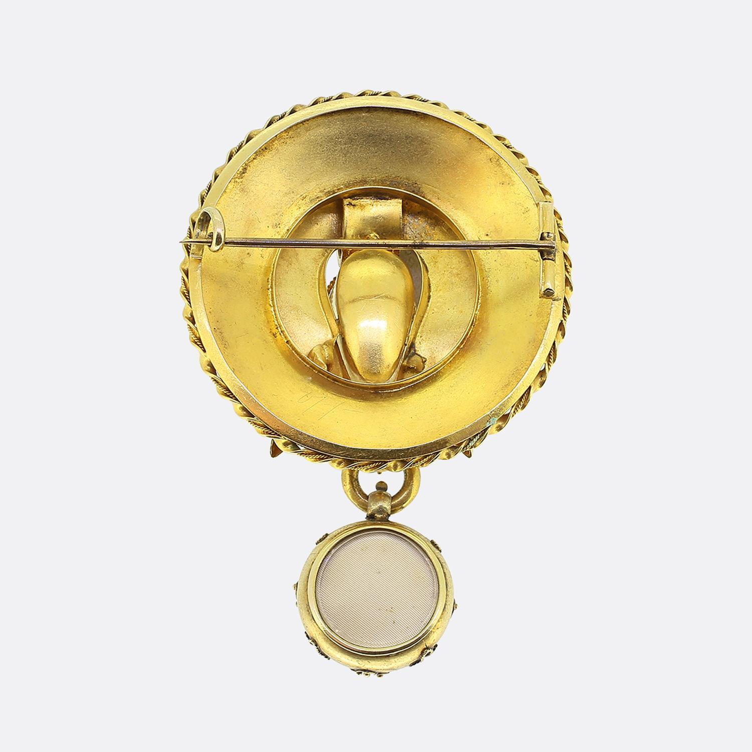 Here we have a fabulous drop brooch dating back to the Victorian period. This rounded piece has been crafted from a rich 18ct yellow gold and features multiple decorated layers consisting of scrolled and ribbed borderings. Swinging freely below the