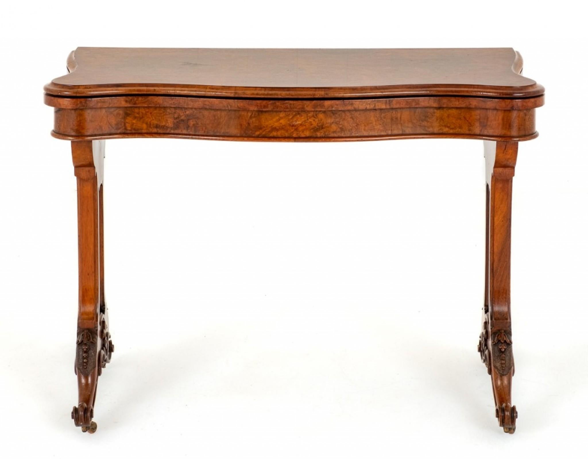 Victorian Burr walnut Card table.
Circa 1860
This Table is Raised upon Shaped Supports with Carved Knees and Carved Toes.
The Supports Feature Pierced Fret Work.
The Top of the Table is of a Serpentine Form and Opens to Reveal a Baize Playing