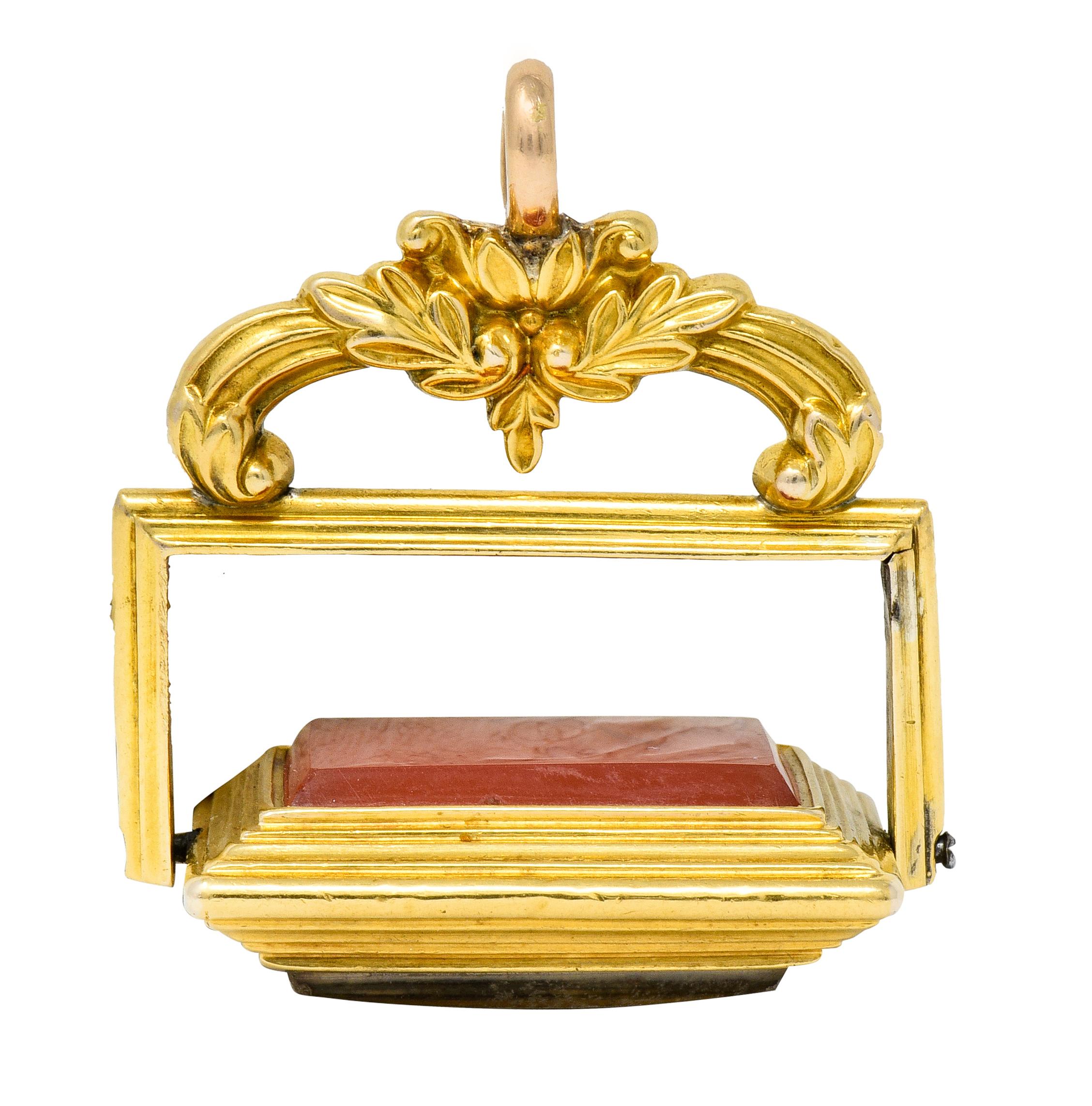 Pendant designed as a whiplash foliate surmount, with loop as bale, terminating as a deeply ridged frame

With a rectangular center that rotates fully around, alternating between carnelian back and still life rendering

Carnelian rectangular tablet