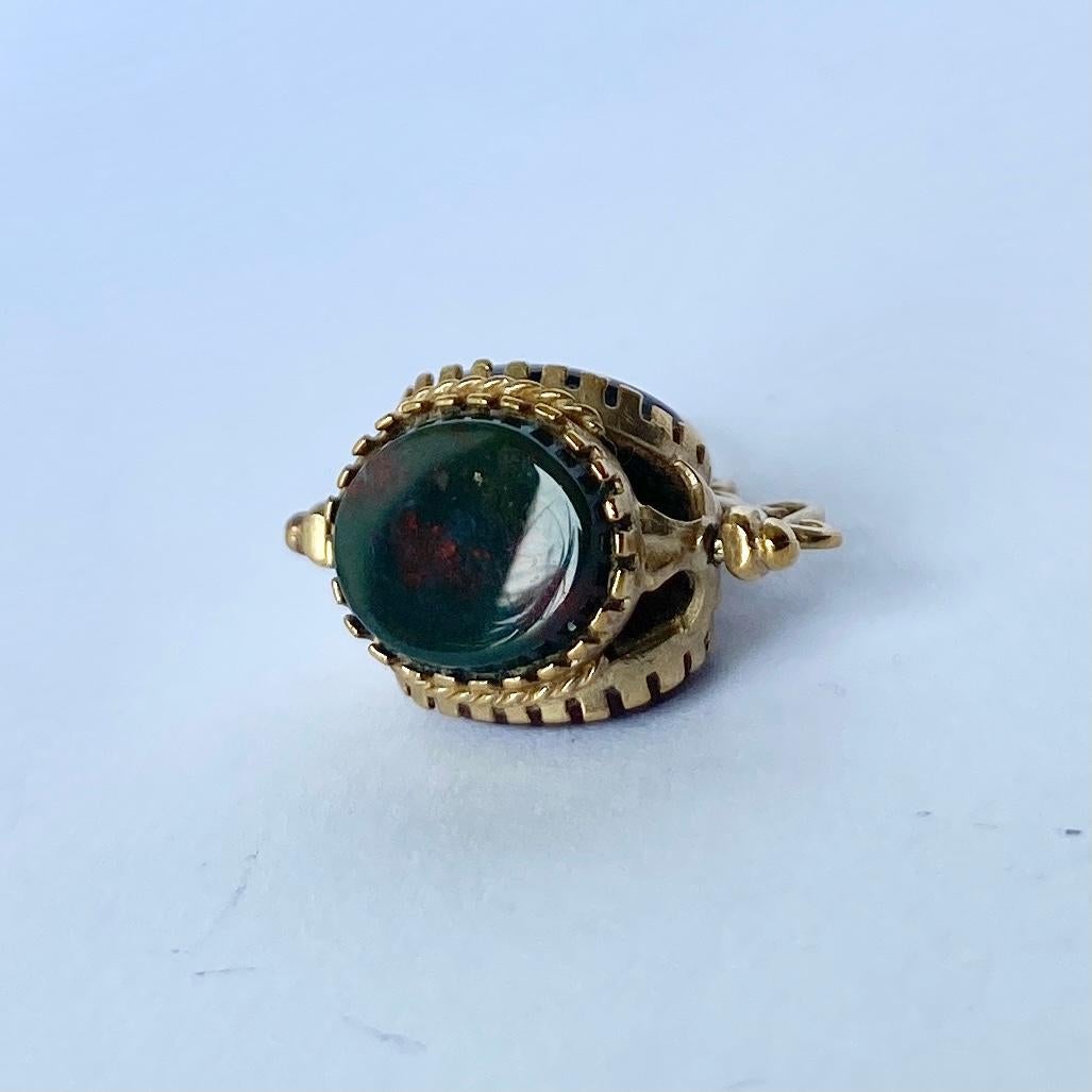 An elaborate Victorian fob pendant. Containing three oval sides of  carnelian, bloodstone and onyx forming a triple side swivelling fob. Which is pivoted beneath a decorative arch and pendant loop. Modelled in 9ct yellow gold.

Height inc loop: