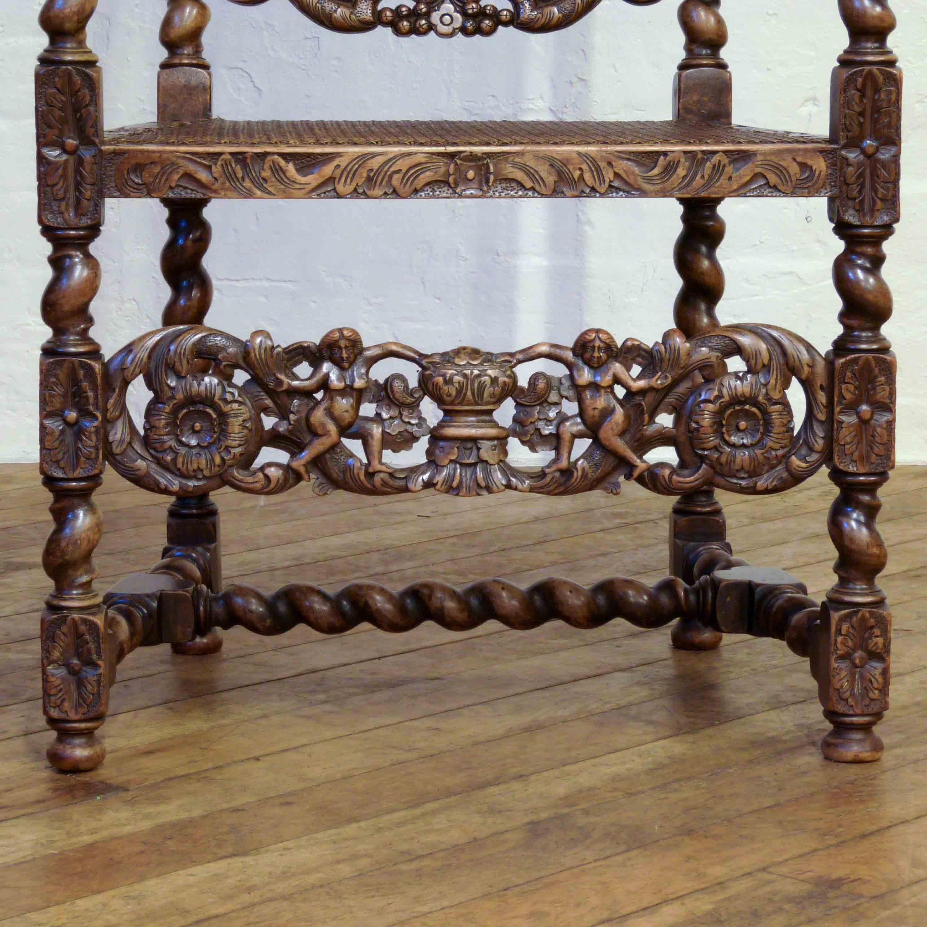 An exceptional walnut chair made in the mid-17th century style. The top rail and lower stretcher carved with foliage, flowers and a pair of winged cherubs. The rest of the chair is carved throughout and the bergere panels to the seat and back are in